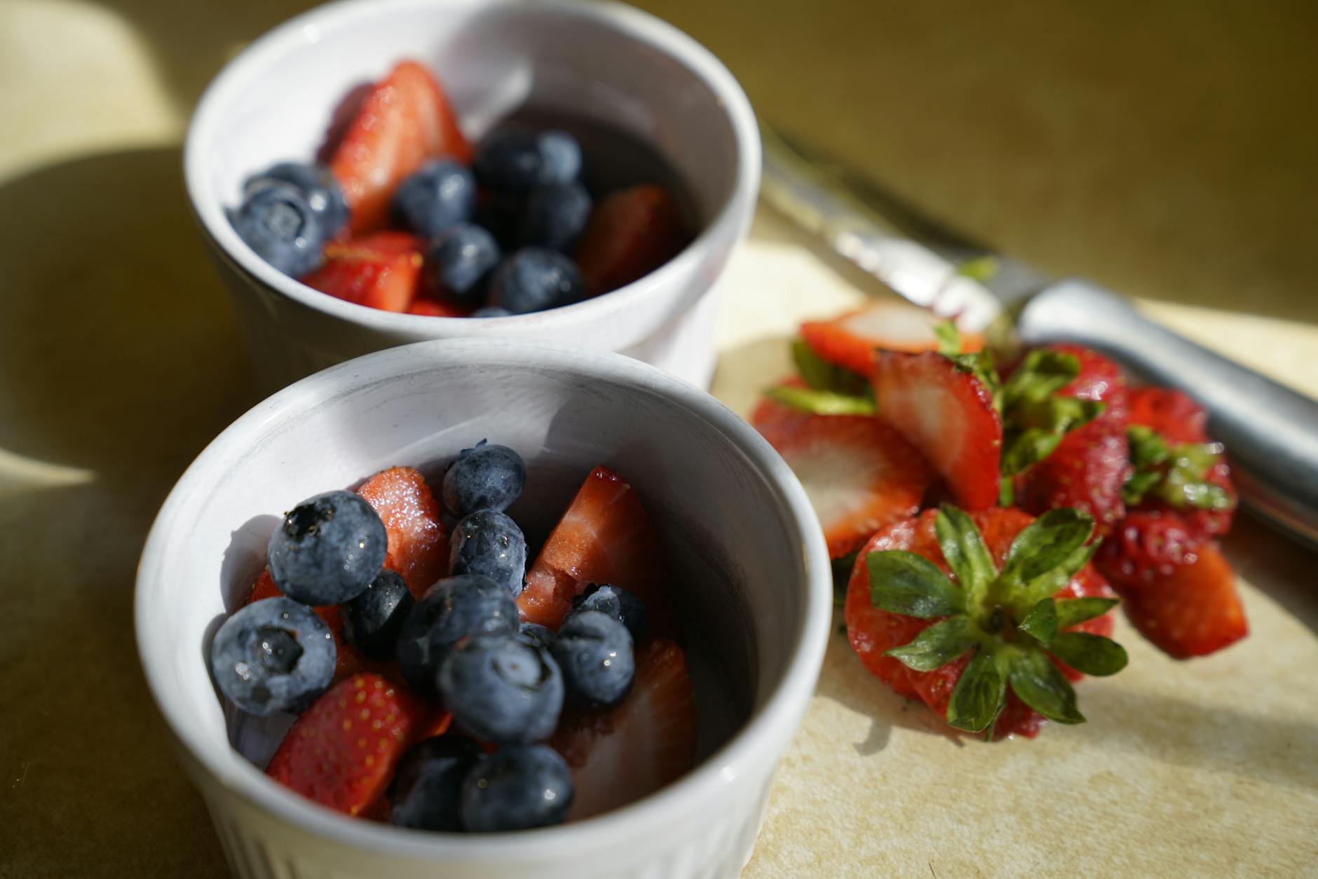 Anti-inflammatory foods including berries shown in ceramic bowls