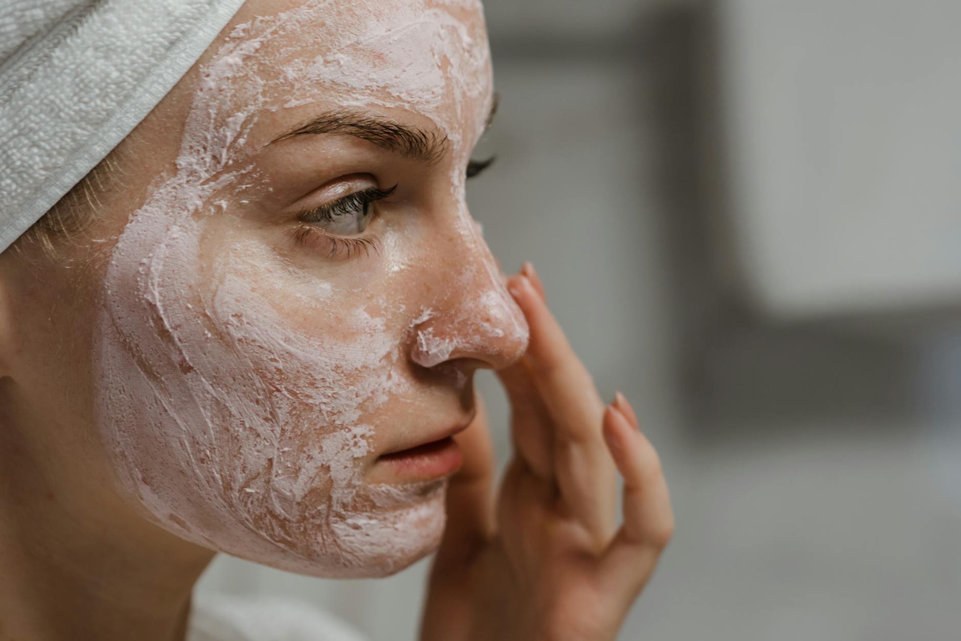 Healthy Glowing Skin Anti-Aging Lifestyle Tips Woman with healthy, radiant skin applying facial cream as part of her skincare routine