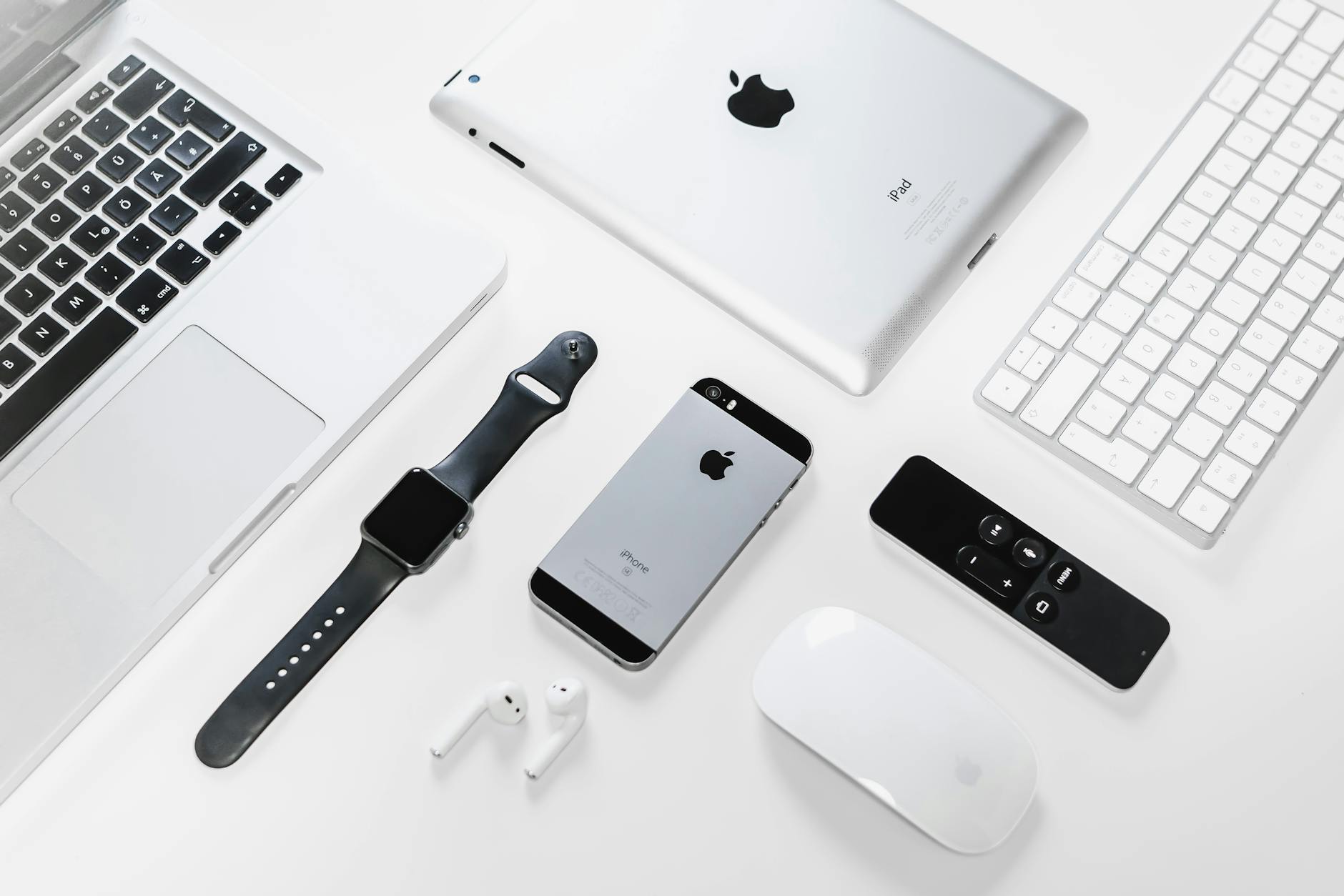Apple Ecosystem Devices — Find My Network 2026 Flat lay of Apple devices including iPhone, iPad, MacBook, and Apple Watch — all part of the Find My network