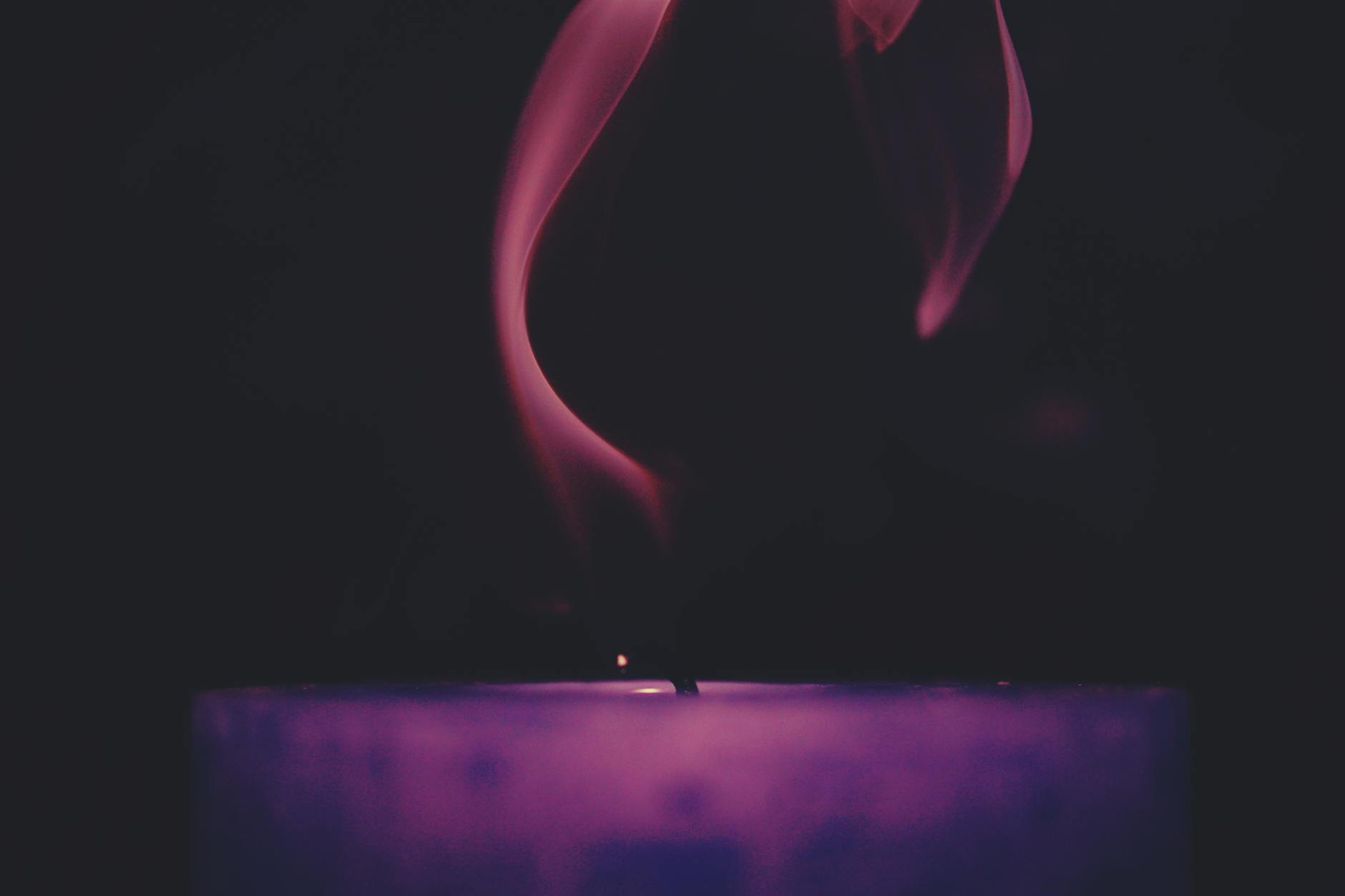 Candle Smoke and Particulate Emissions Close-up of smoke curling from a candle wick, illustrating particulate emissions from burning candles