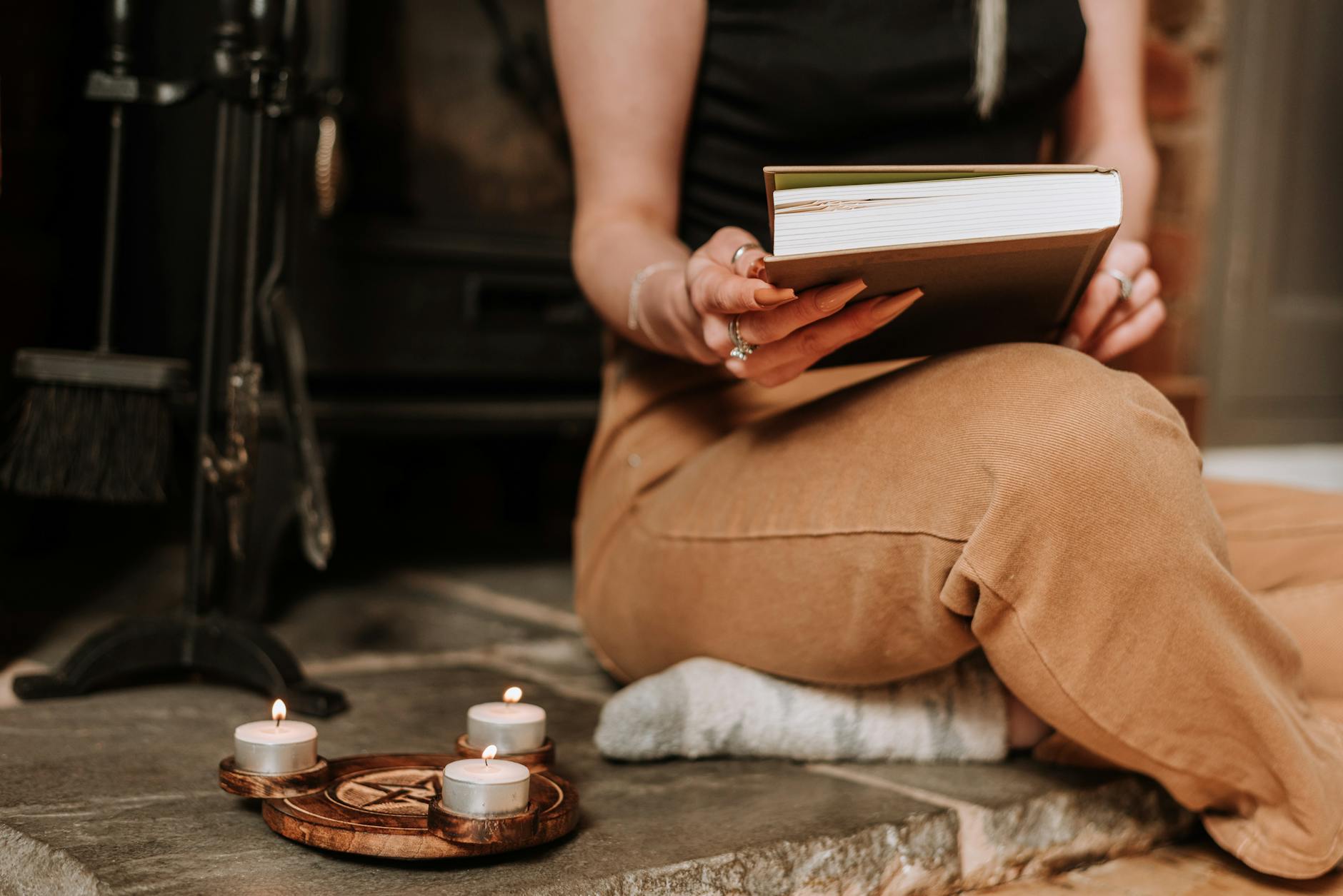 Everyday Candle Use and Indoor Air Quality Person reading by candlelight at home, illustrating everyday candle use and indoor air quality concerns