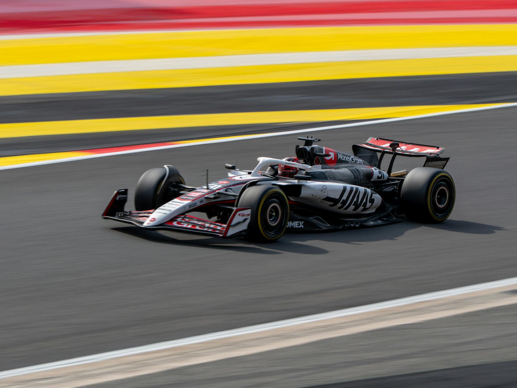 Formula 1 car at speed on the colourful race circuit in Belgium