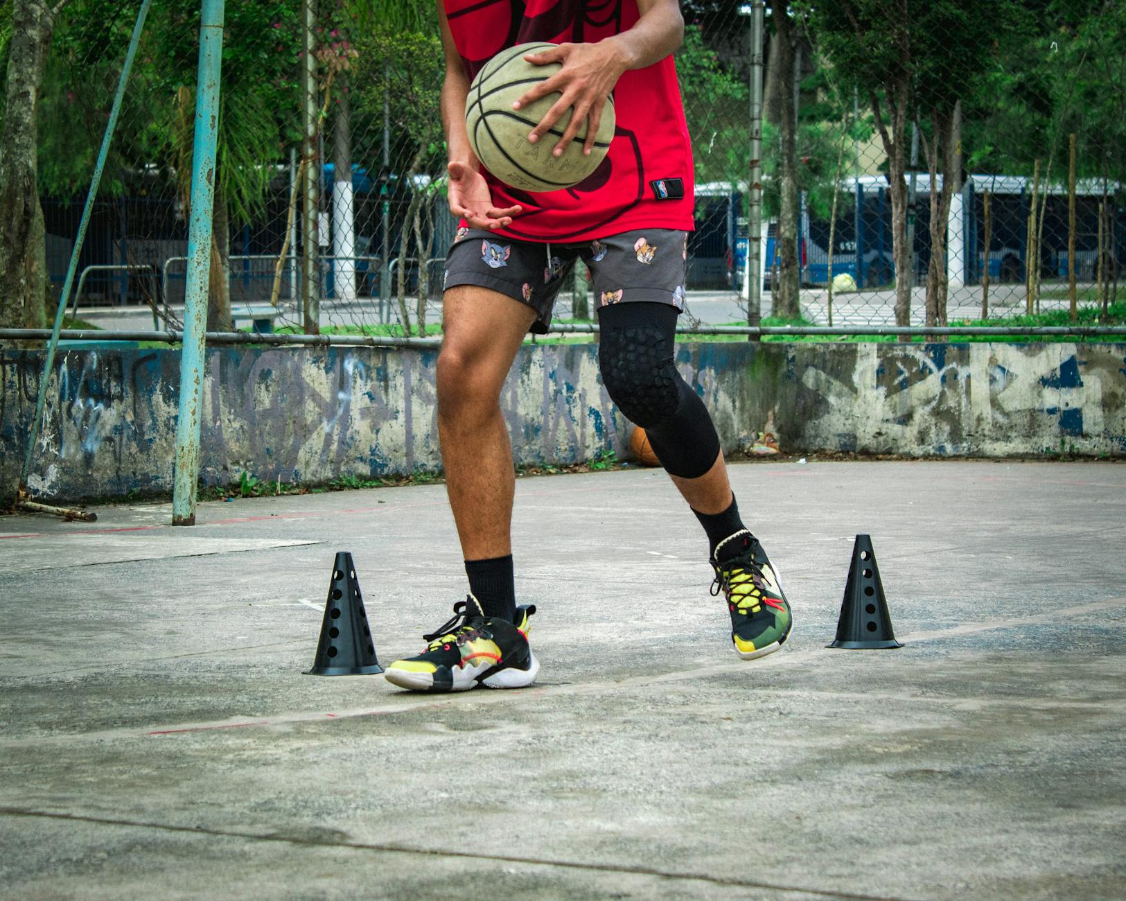 Basketball player practicing agility drills with training cones