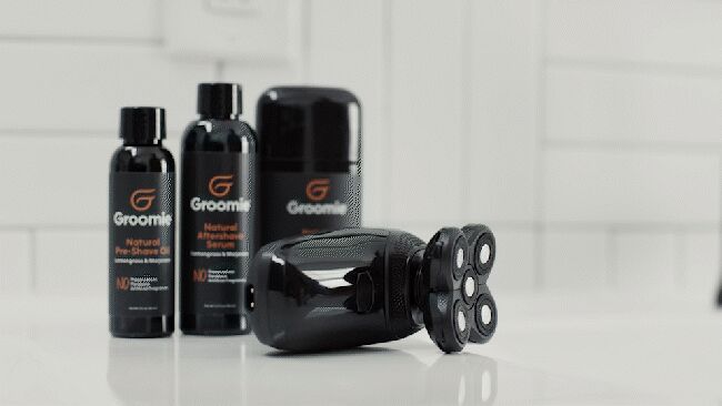 BaldiePro Groomie head shaver being used on body and leg demonstrating wet and dry versatility