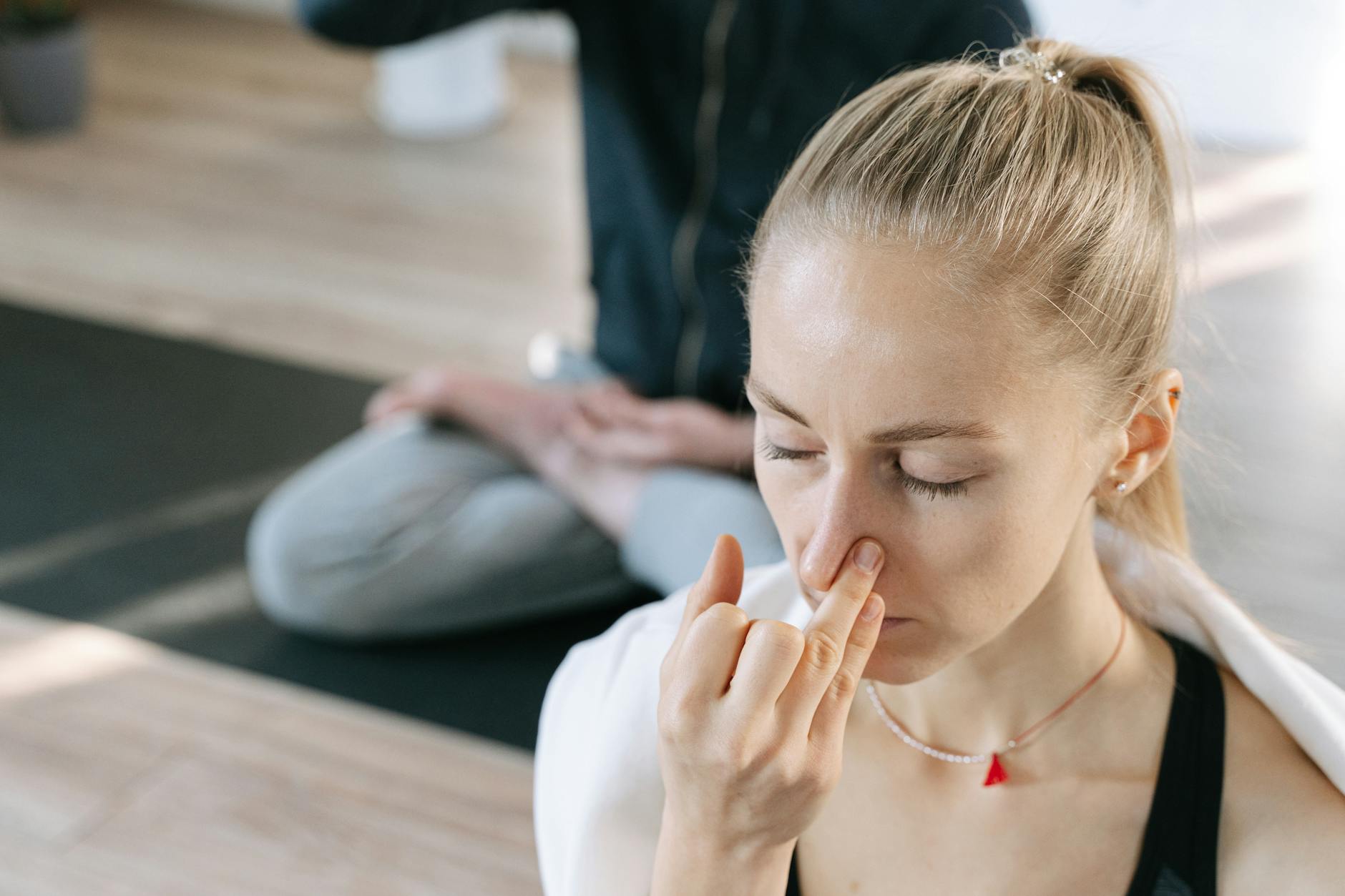 Yoga Breathing Techniques for Stress Relief Woman practicing yoga breathing techniques indoors with focused concentration