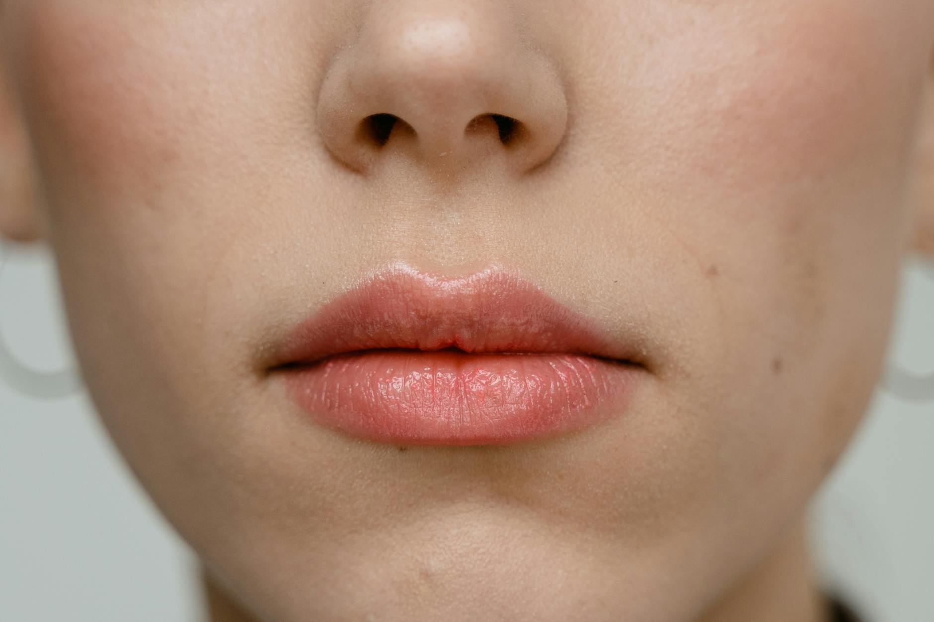 Close-up of a woman's face showing clear skin — the result of consistent skincare and hair removal care