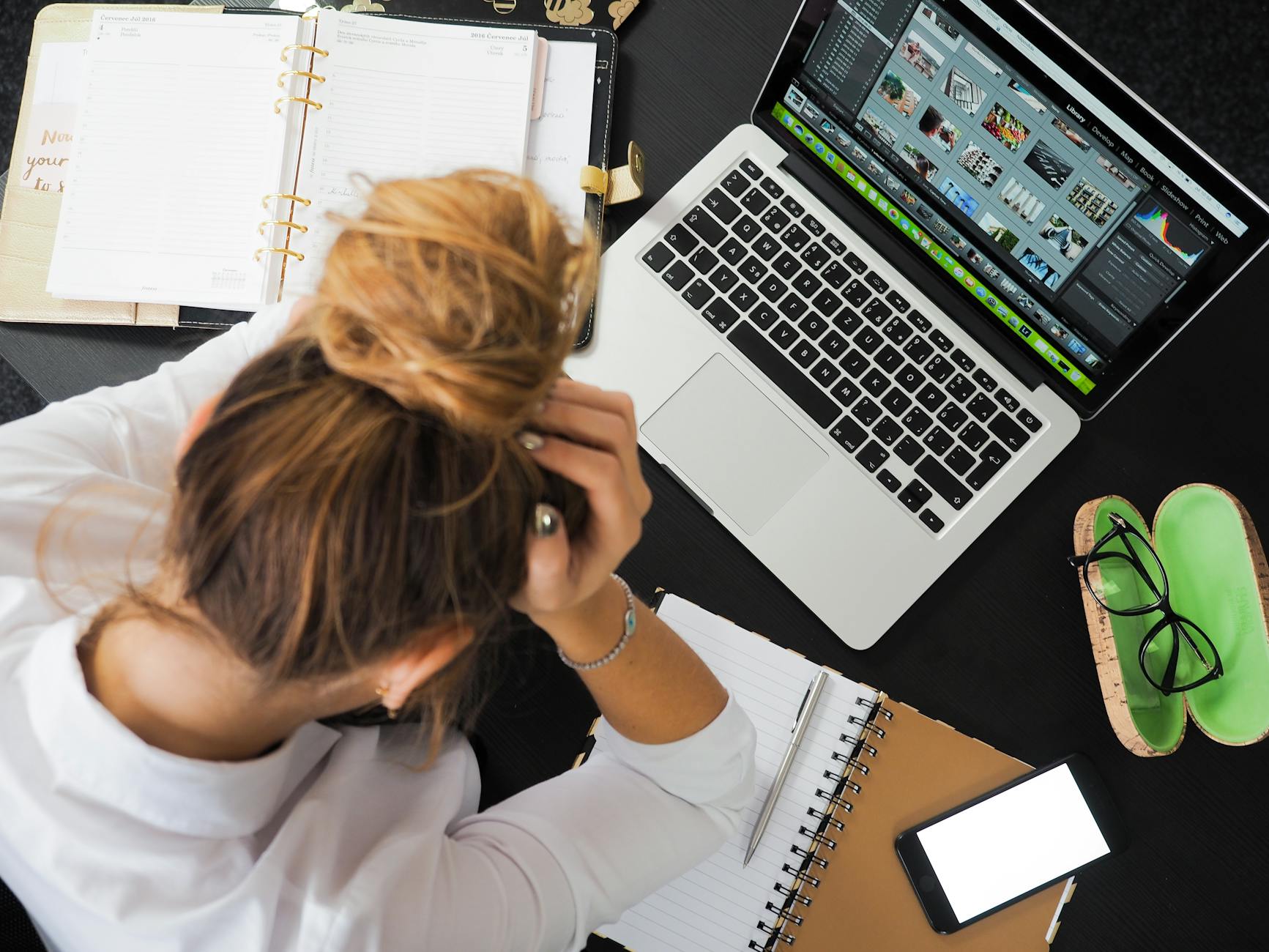 Person feeling overwhelmed at a desk, representing the frustration of cleaning that never seems to work