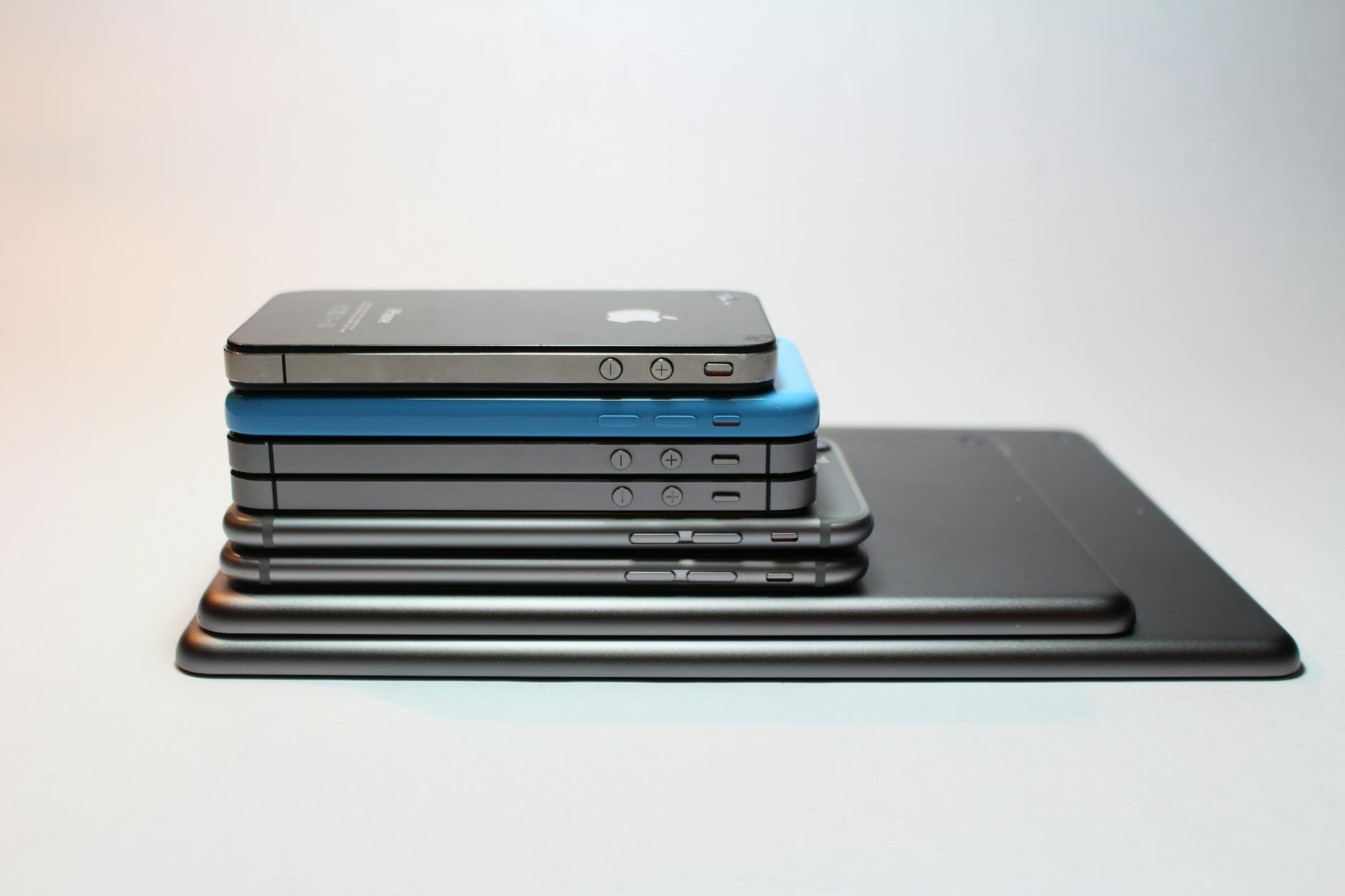 Stacked modern smartphones and tablets representing the latest tech gadgets available in 2026