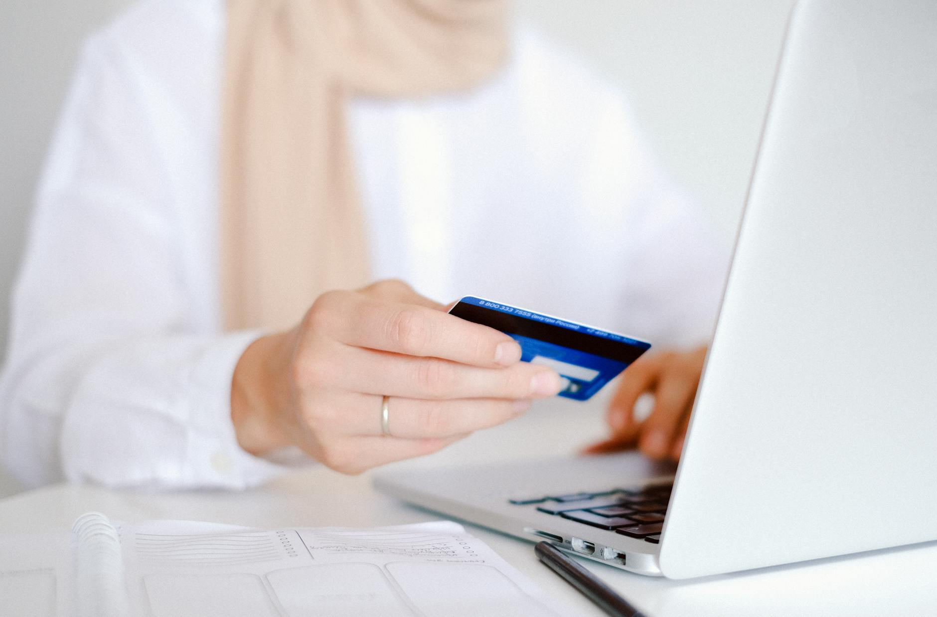 Person entering credit card details securely on a laptop for online shopping