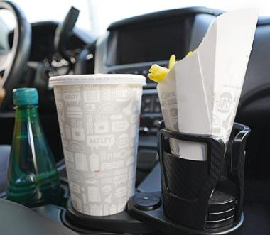 CupStation Holding Large Bottle 2026 Large water bottle secured in CupStation expandable cupholder organizer inside vehicle