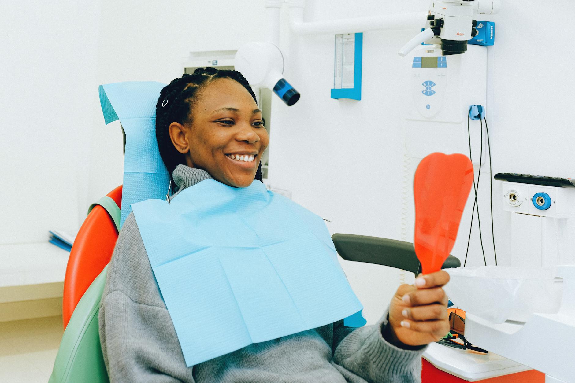 Woman smiling confidently during a dental check-up, showing positive outcome of overcoming dental anxiety
