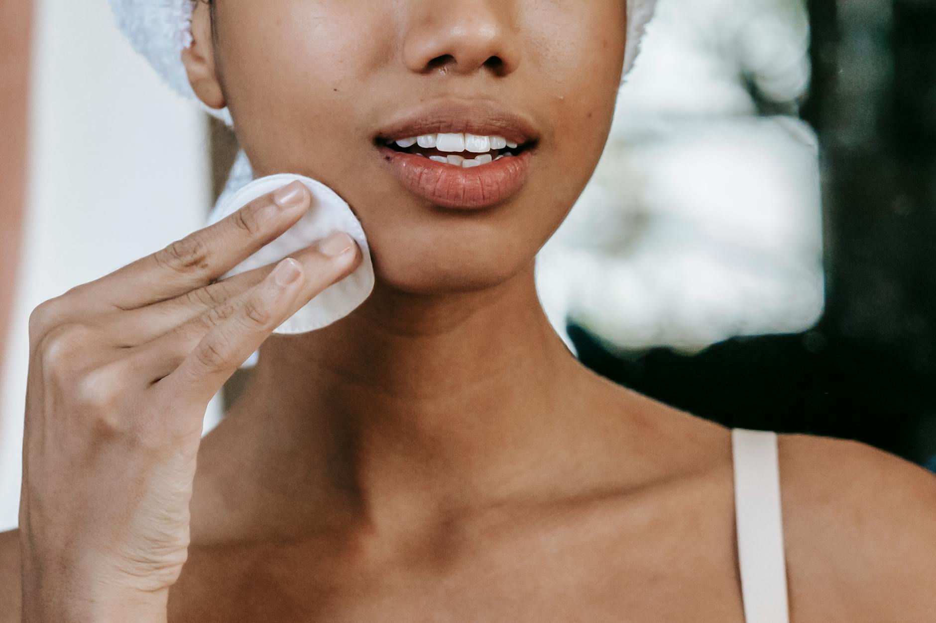 Woman applying skincare as part of a gentle facial hair removal routine