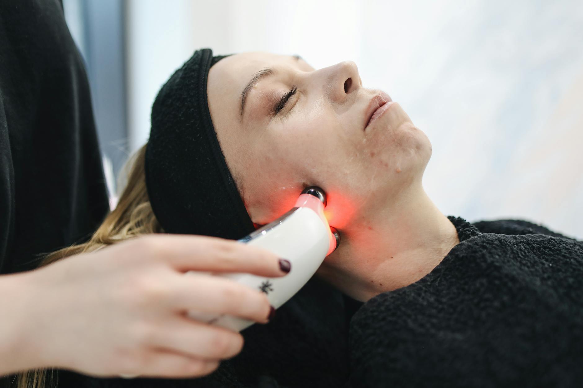 Professional LED Facial Treatment Clinic Woman receiving professional LED light facial treatment at a modern skincare clinic