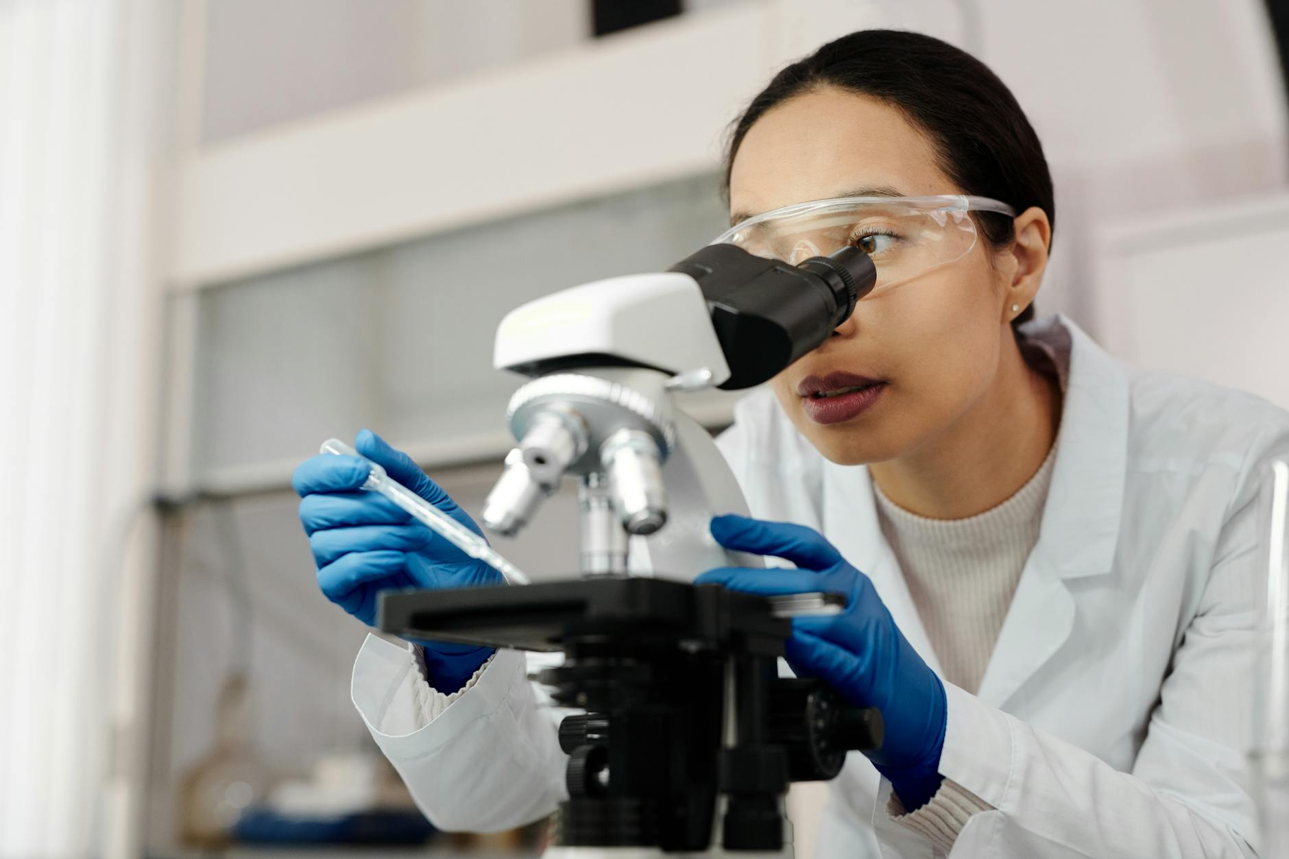 Skincare Science Laboratory Research 2026 Scientist examining skin samples under microscope in laboratory studying photobiomodulation research