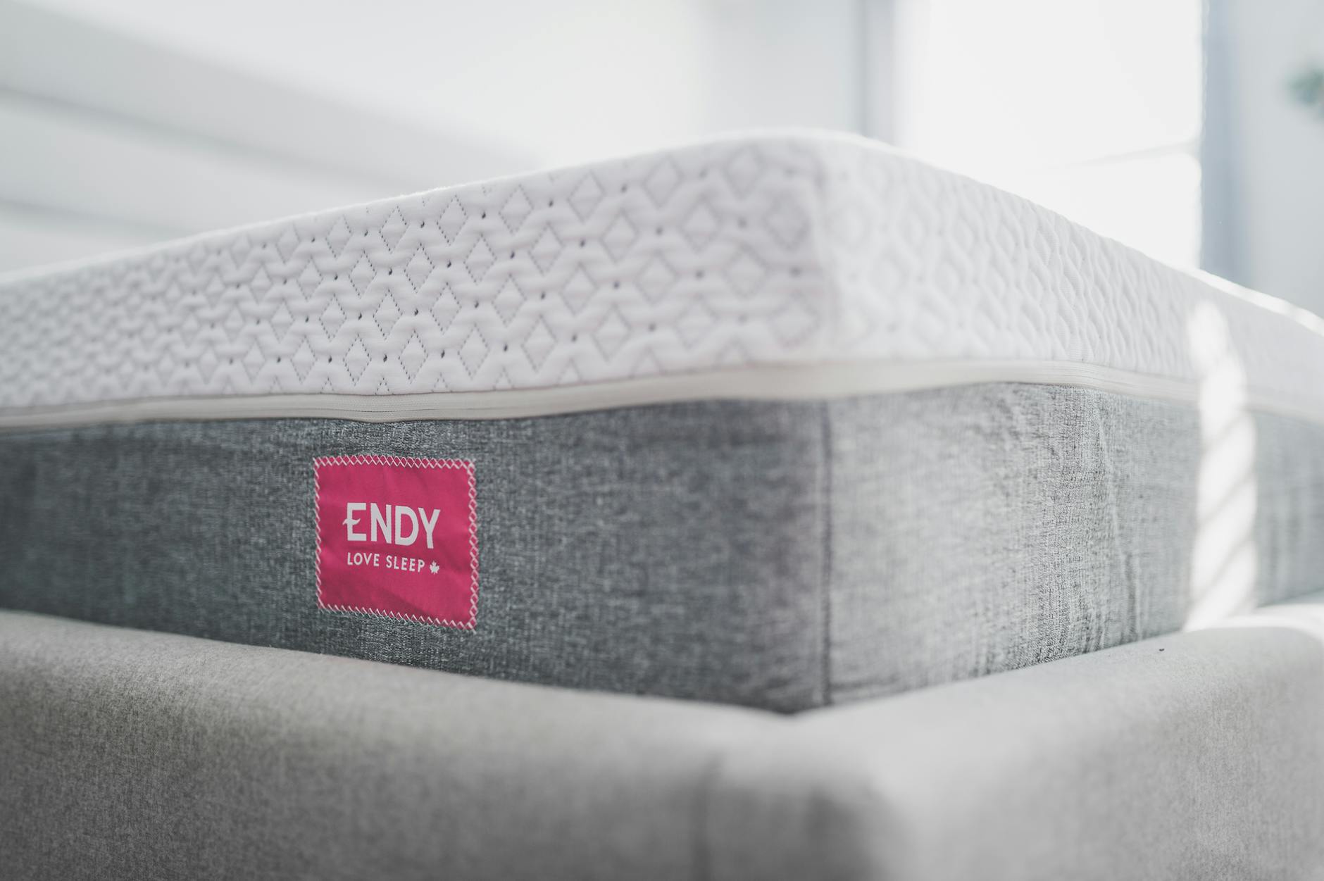 A clean, well-maintained mattress and bedding in a modern bedroom — regular encasements and hot washing are essential for controlling dust mites in bed