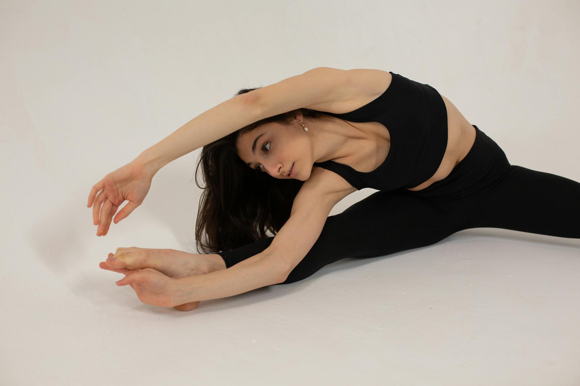 Woman demonstrating a stretching exercise — similar movements help prevent DVT on long flights