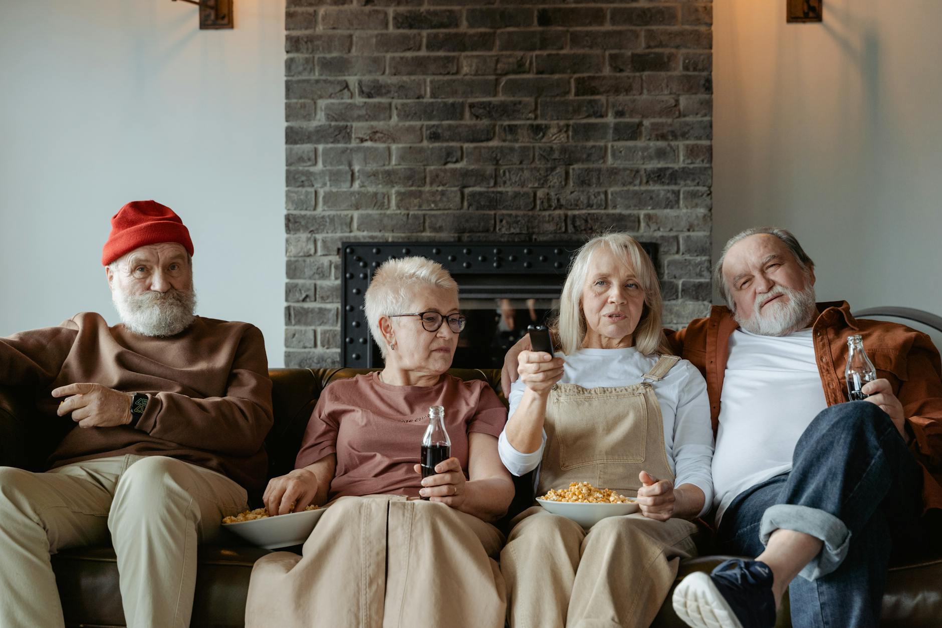 Elderly friends watching television together indoors