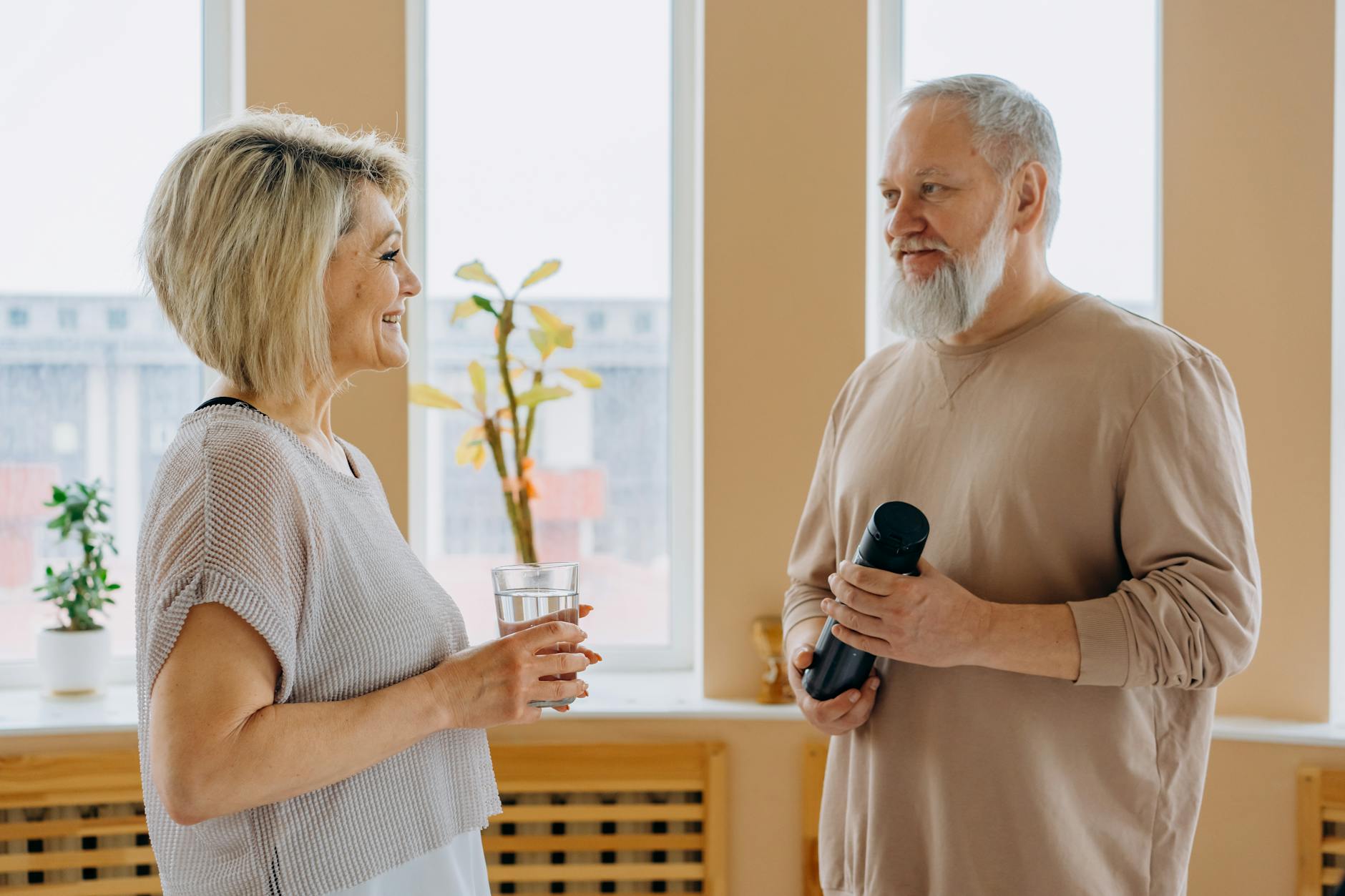 Senior couple smiling and talking together indoors