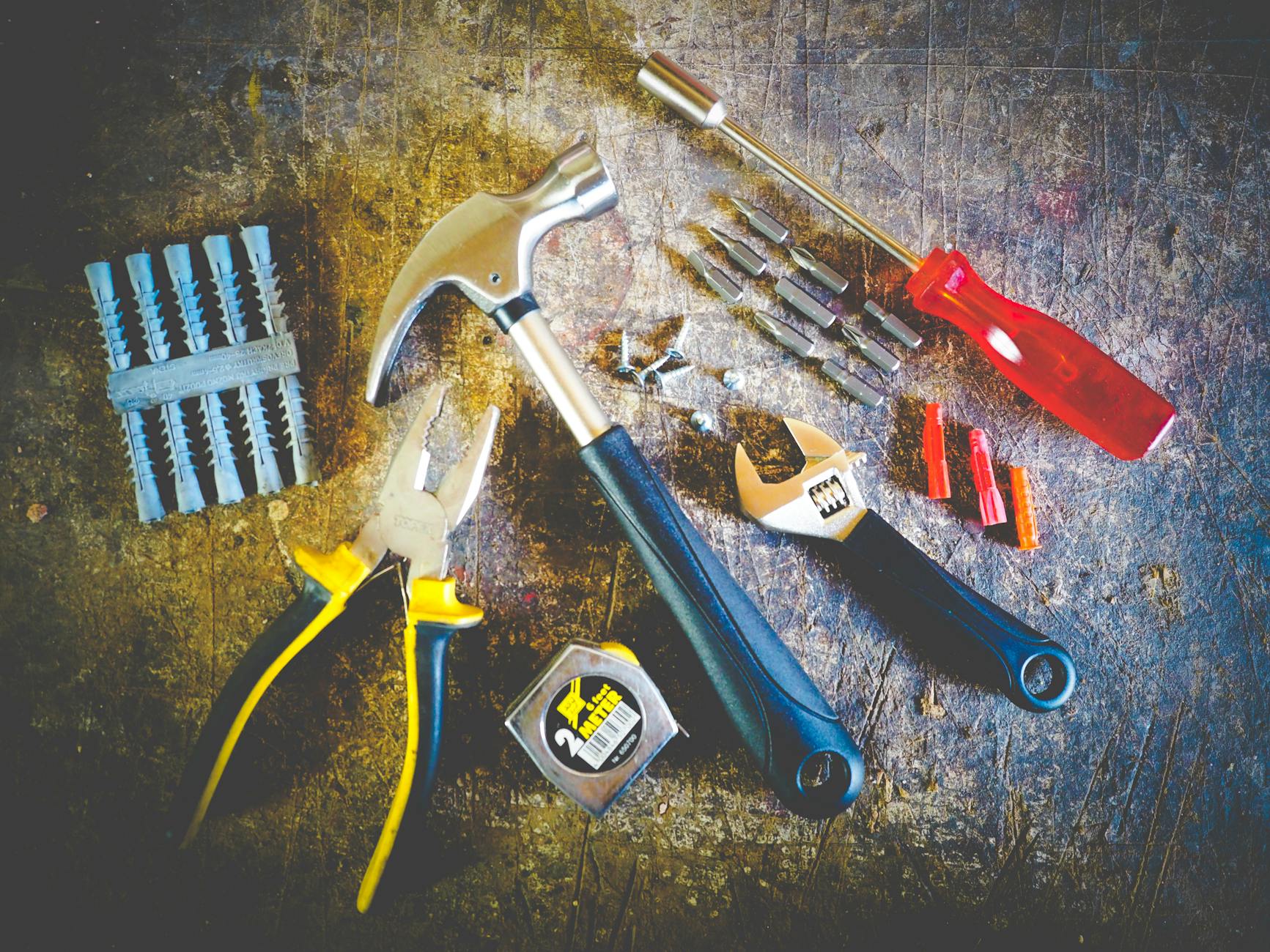 Collection of common hand tools for easy household repairs including hammer, screwdriver and pliers