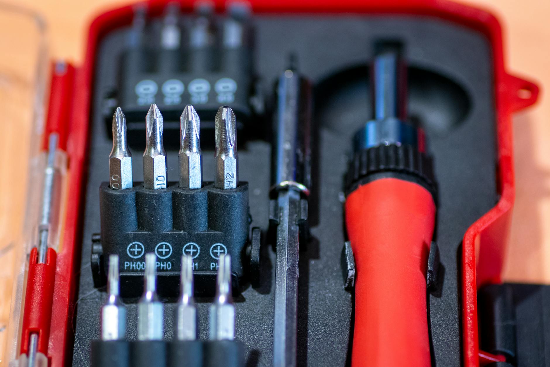 Screwdriver set in red case with interchangeable bits for beginner DIY household repairs
