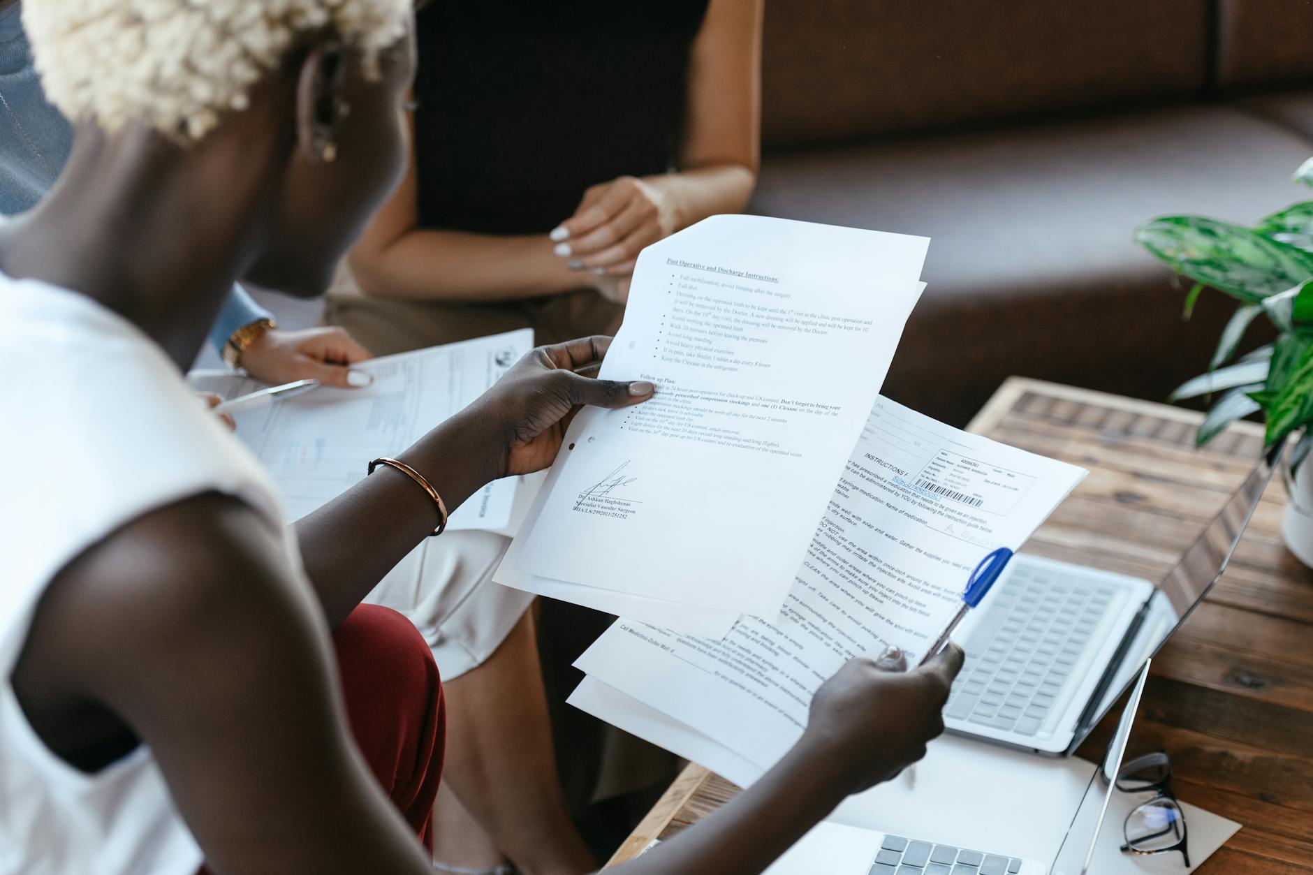 Woman researching and comparing treatment options at a desk with documents