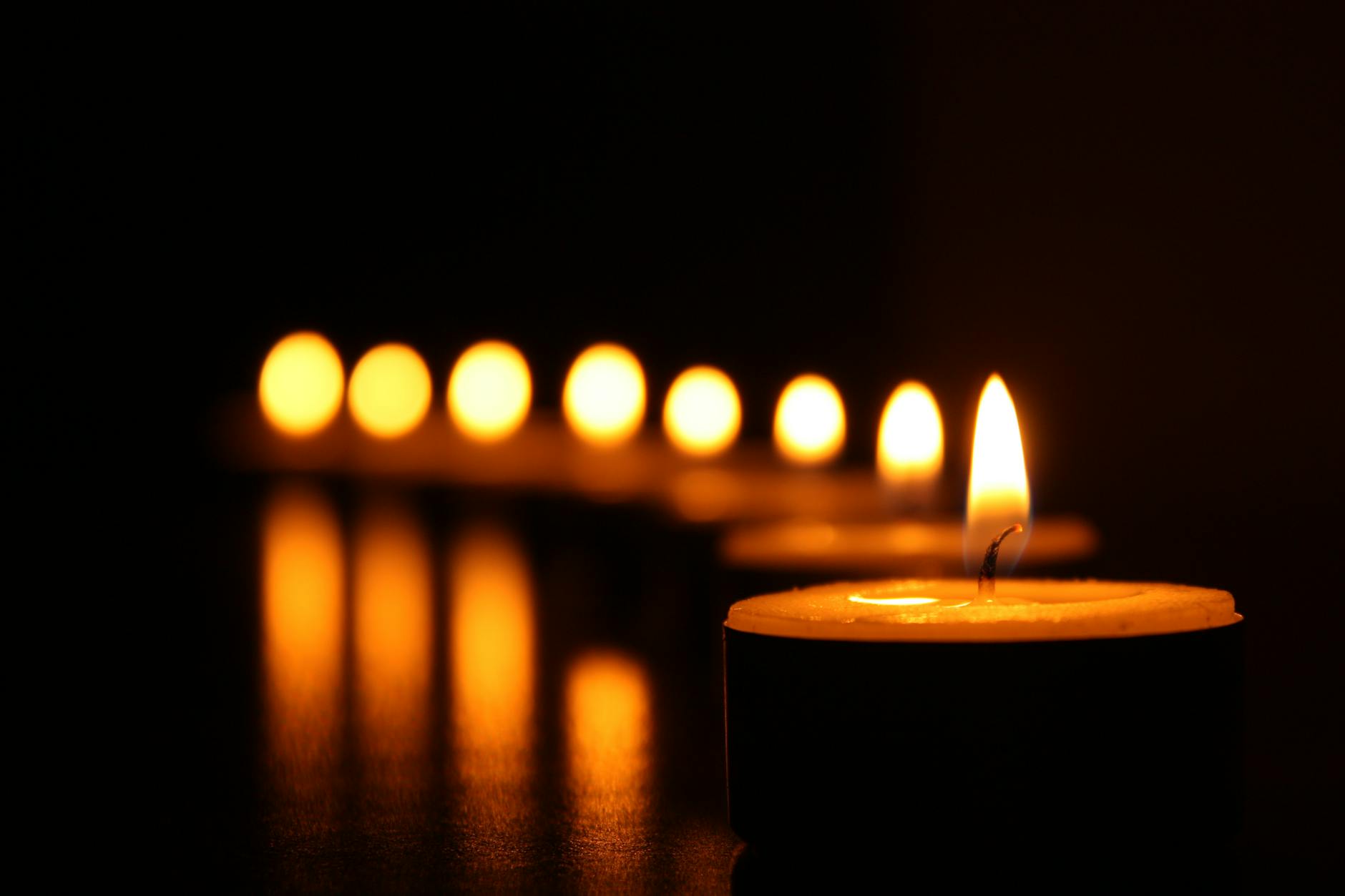 Power Outage at Home - Emergency Preparedness Planning Tealight candles glowing in the dark during a power outage