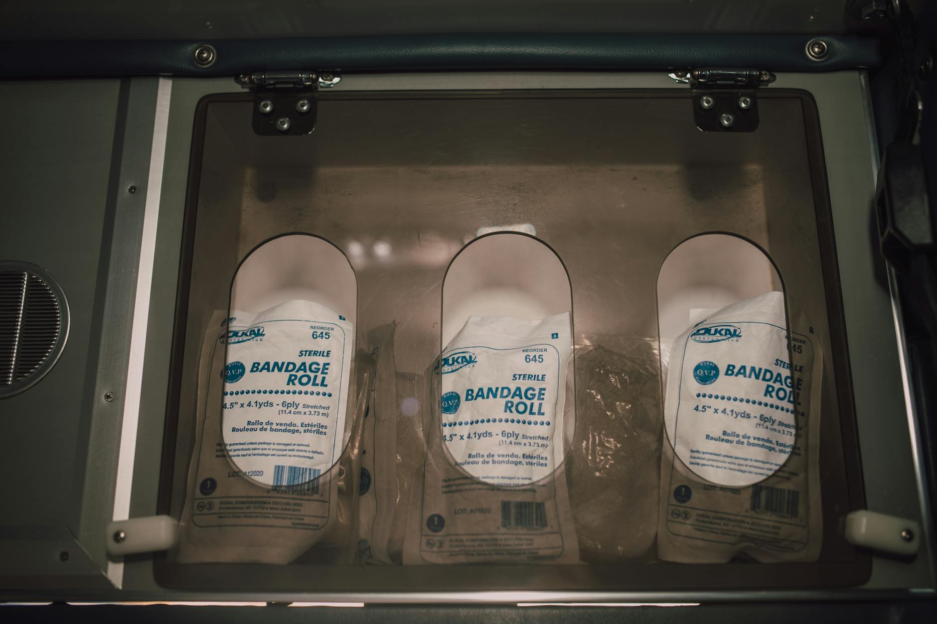 Sterile bandage rolls and medical supplies stored in a first aid container