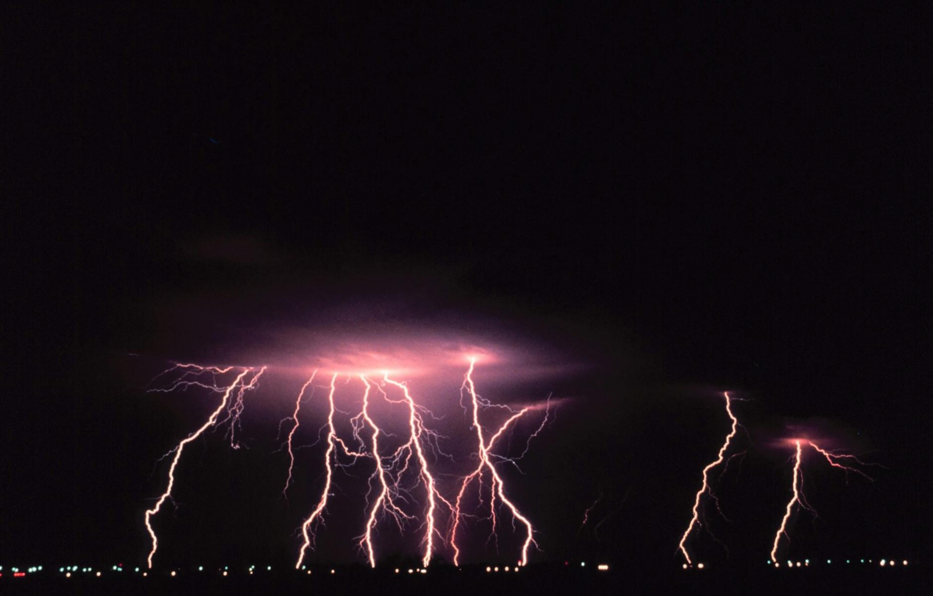 Lightning storm over a city illustrating the unpredictability of natural disasters