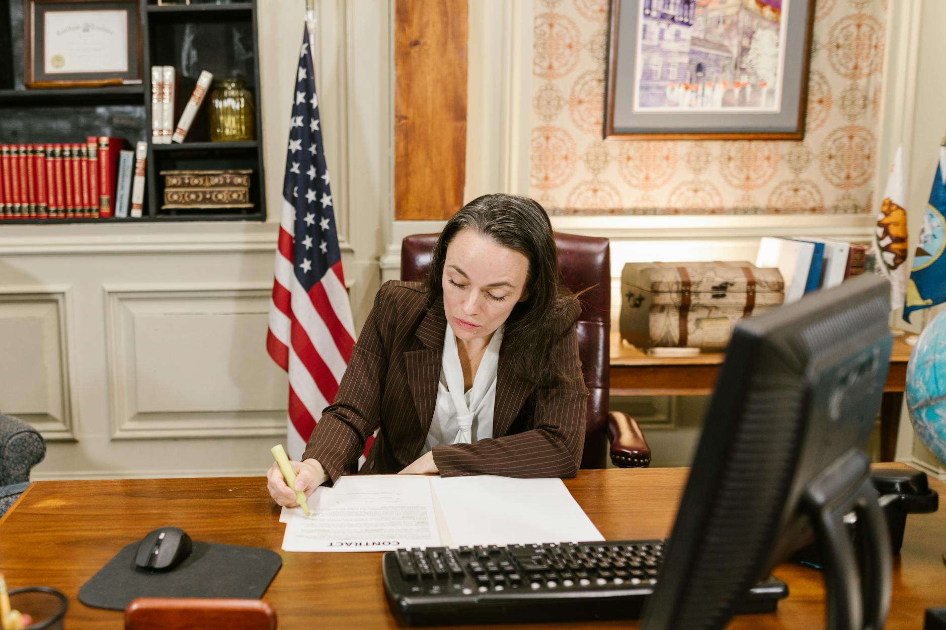 Attorney signing legal estate planning documents at desk