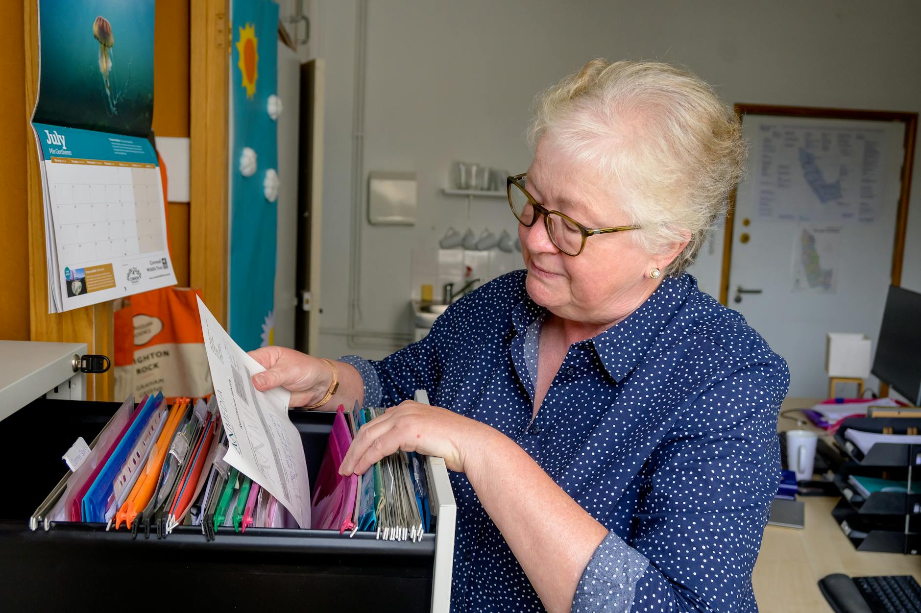 Organizing Important Documents for Emergency Preparedness Person carefully sorting and organizing important paperwork for a family emergency binder