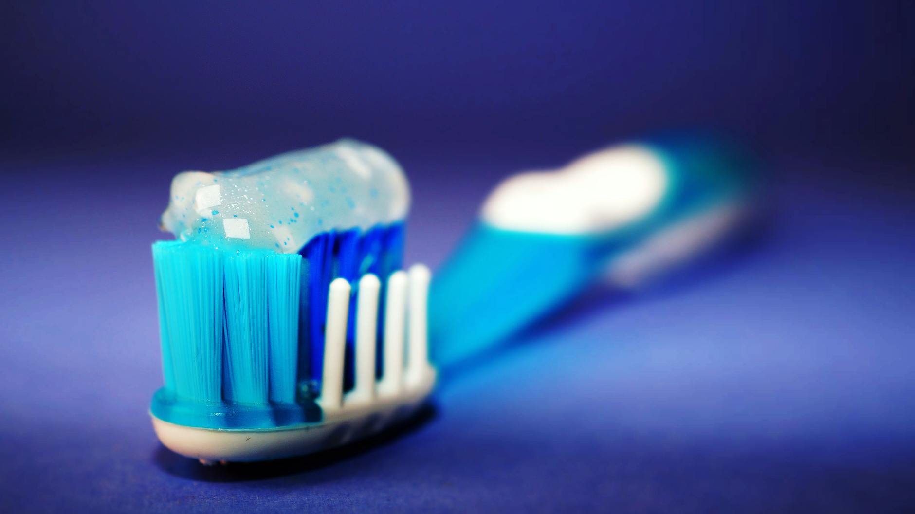 Toothbrush with toothpaste representing the daily dental care decision