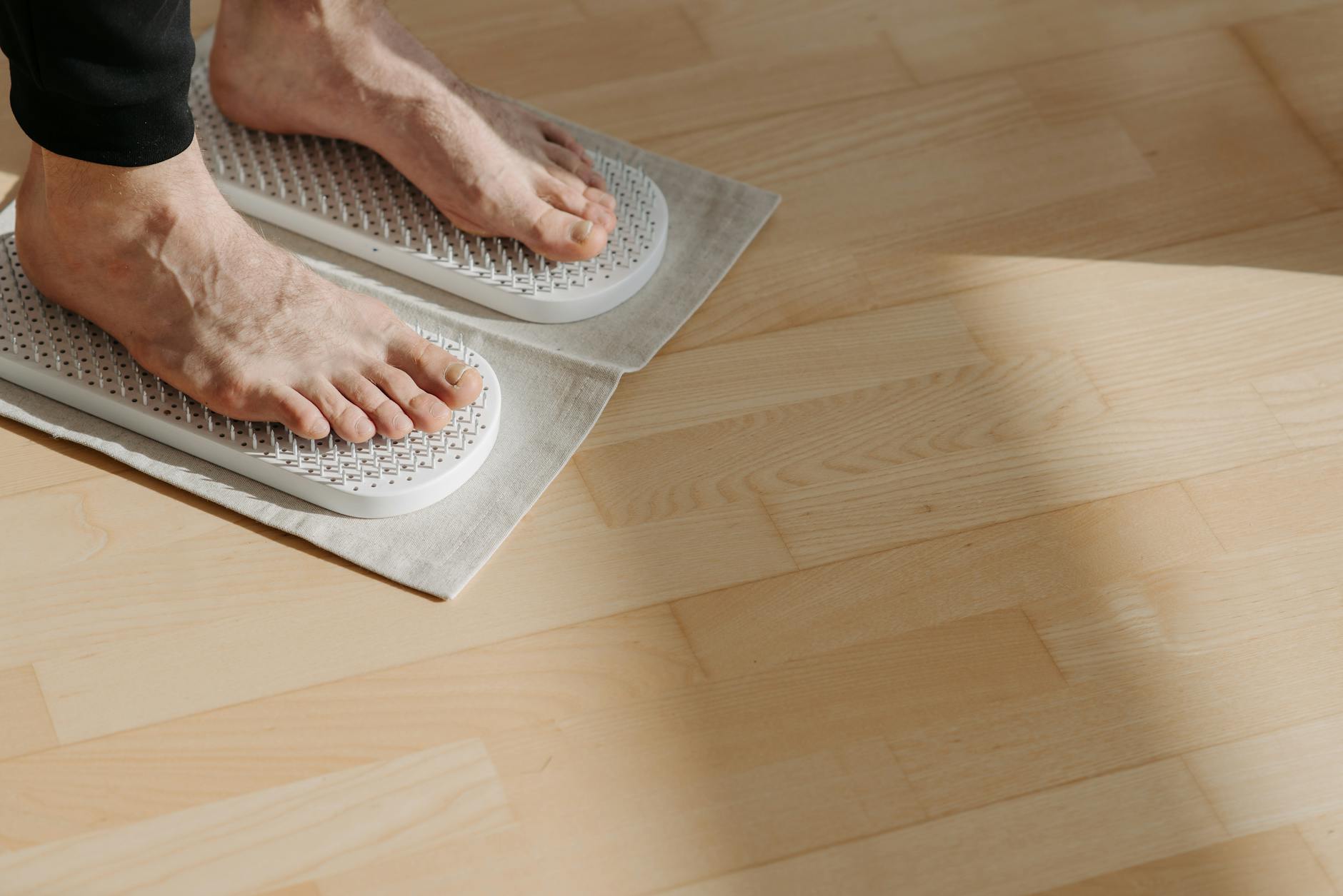 Bare feet on a wooden floor demonstrating foot awareness and mindful exercise positioning