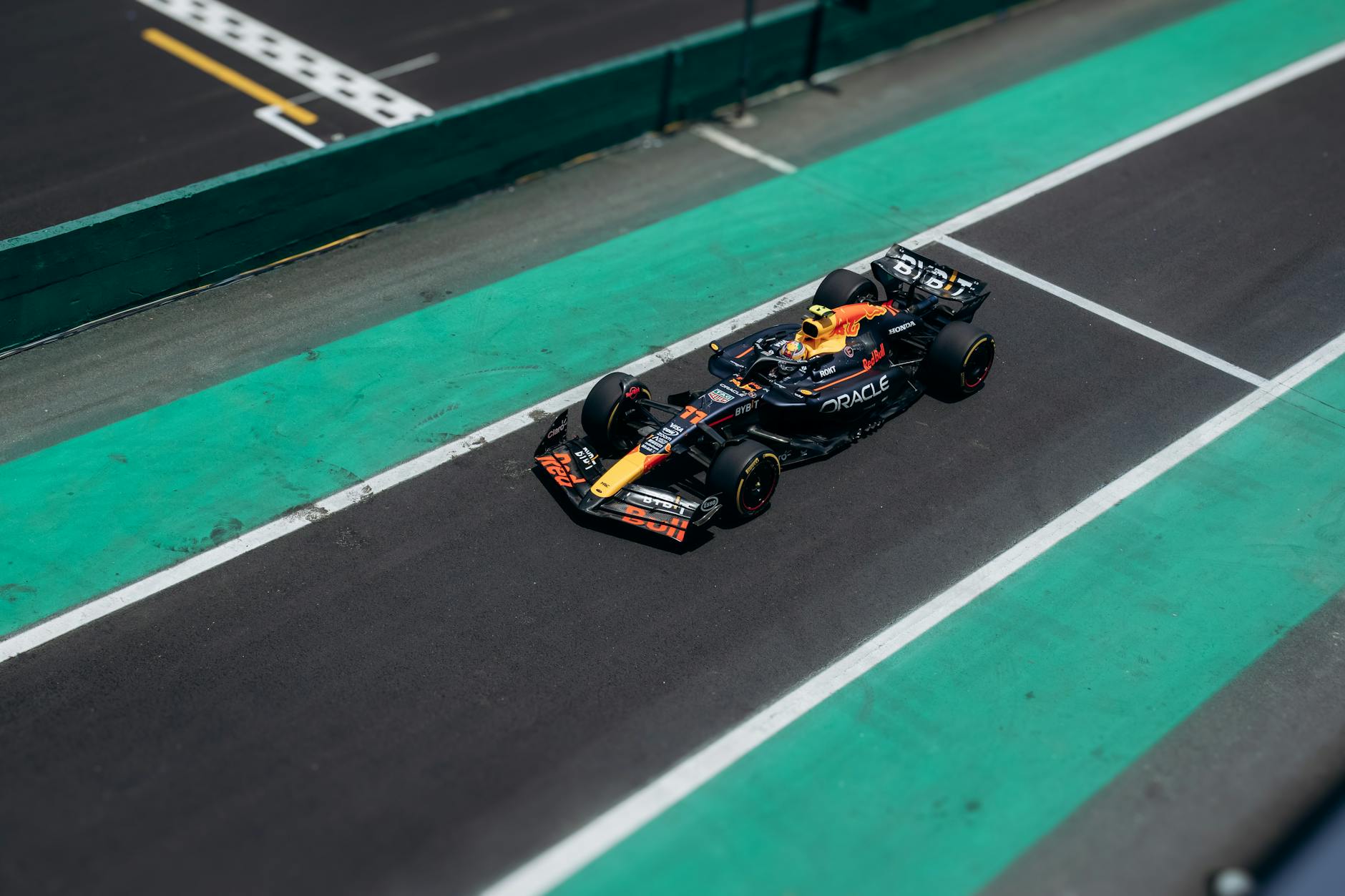 Aerial view of F1 race track with Formula 1 car racing at high speed