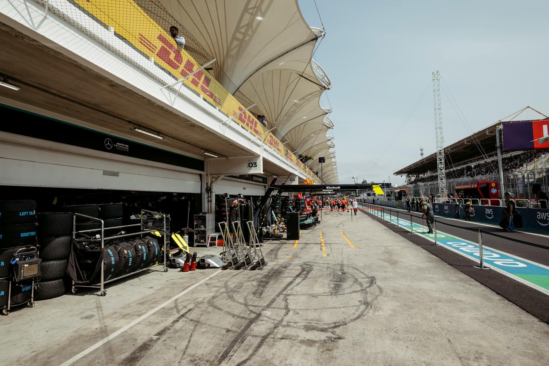Formula 1 pit lane with garages visible and race equipment during a grand prix weekend
