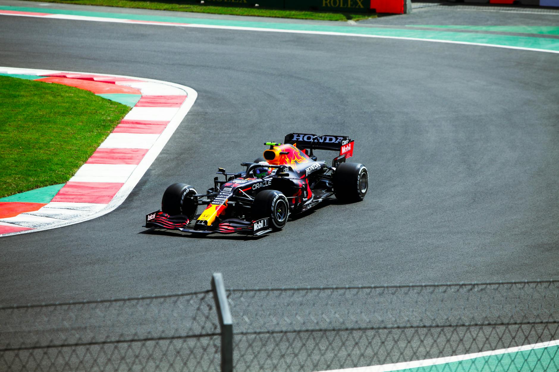 Formula One car racing at high speed through a grand prix circuit corner