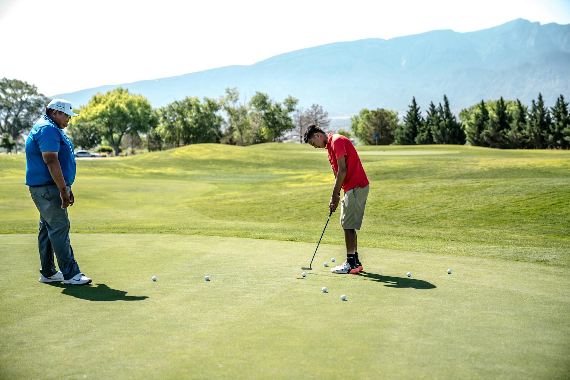 Golf Putting Green Etiquette for Beginners Two golfers practicing on the putting green on a sunny day — learning proper green etiquette is a key part of golf rules for beginners