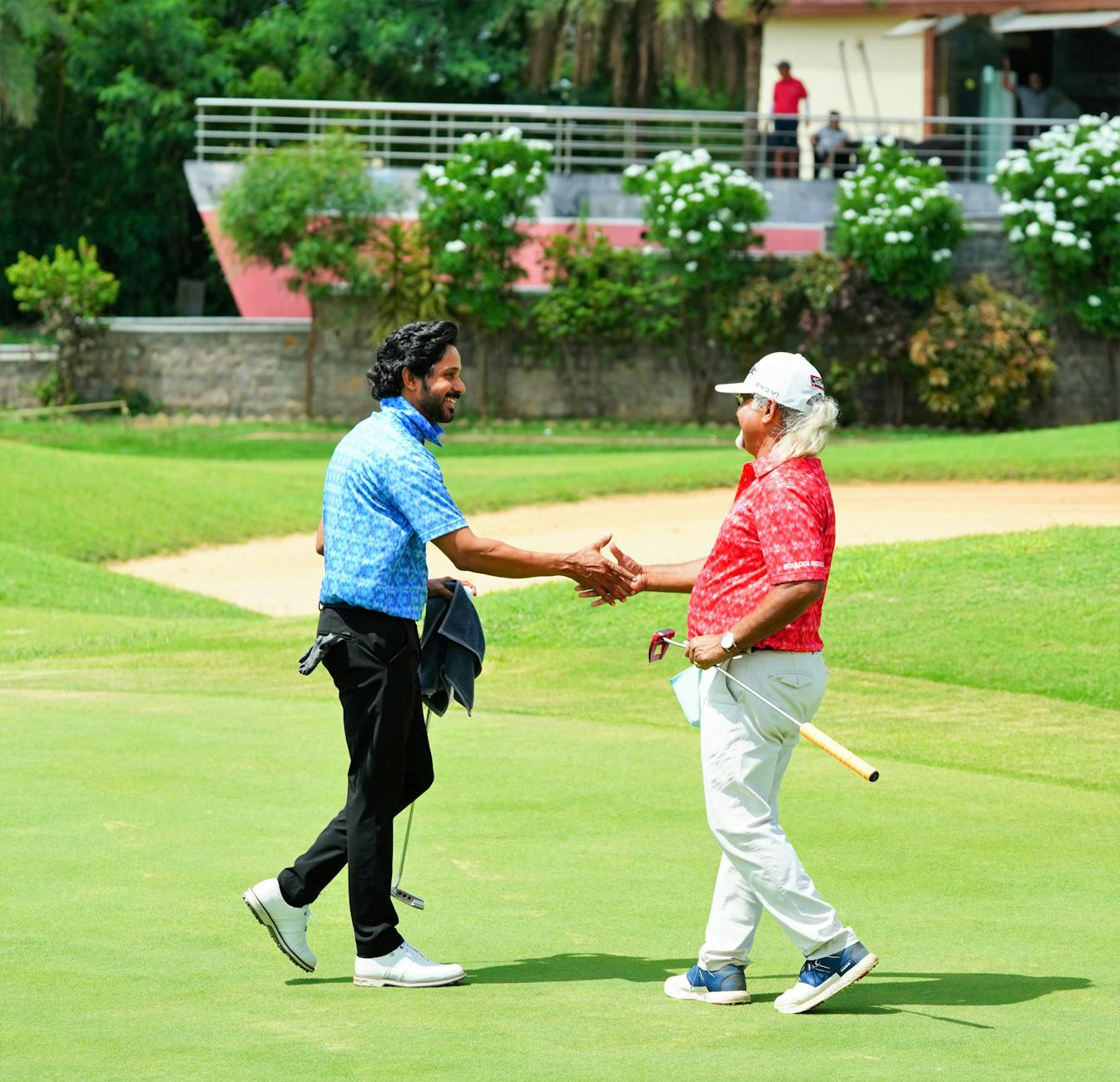 Golf Sportsmanship and Etiquette — Shaking Hands After a Round Two golfers shaking hands on the course — sportsmanship and knowing how to ask for help are central to golf etiquette rules