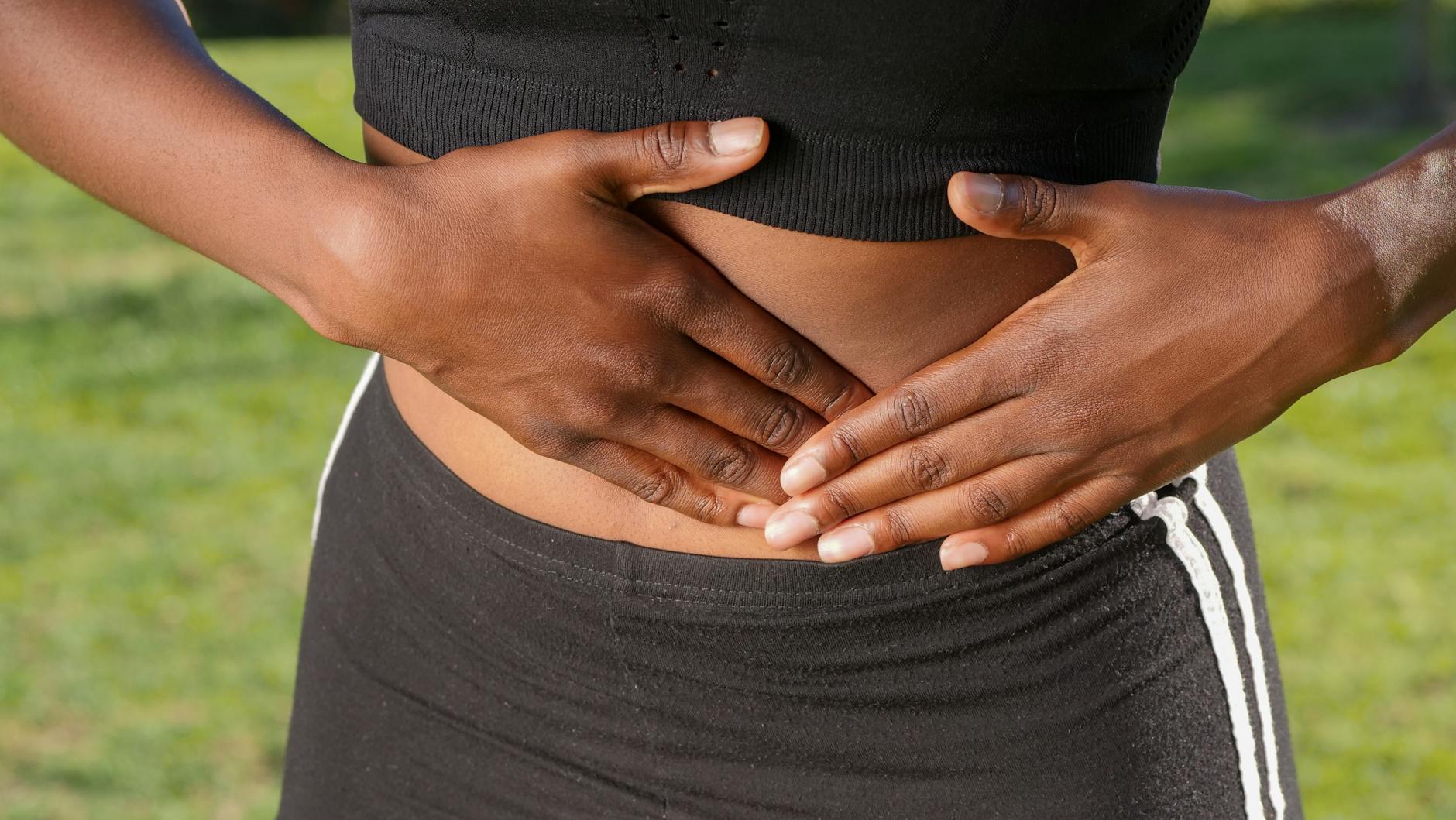 Person experiencing abdominal pain and digestive discomfort linked to stress and IBS