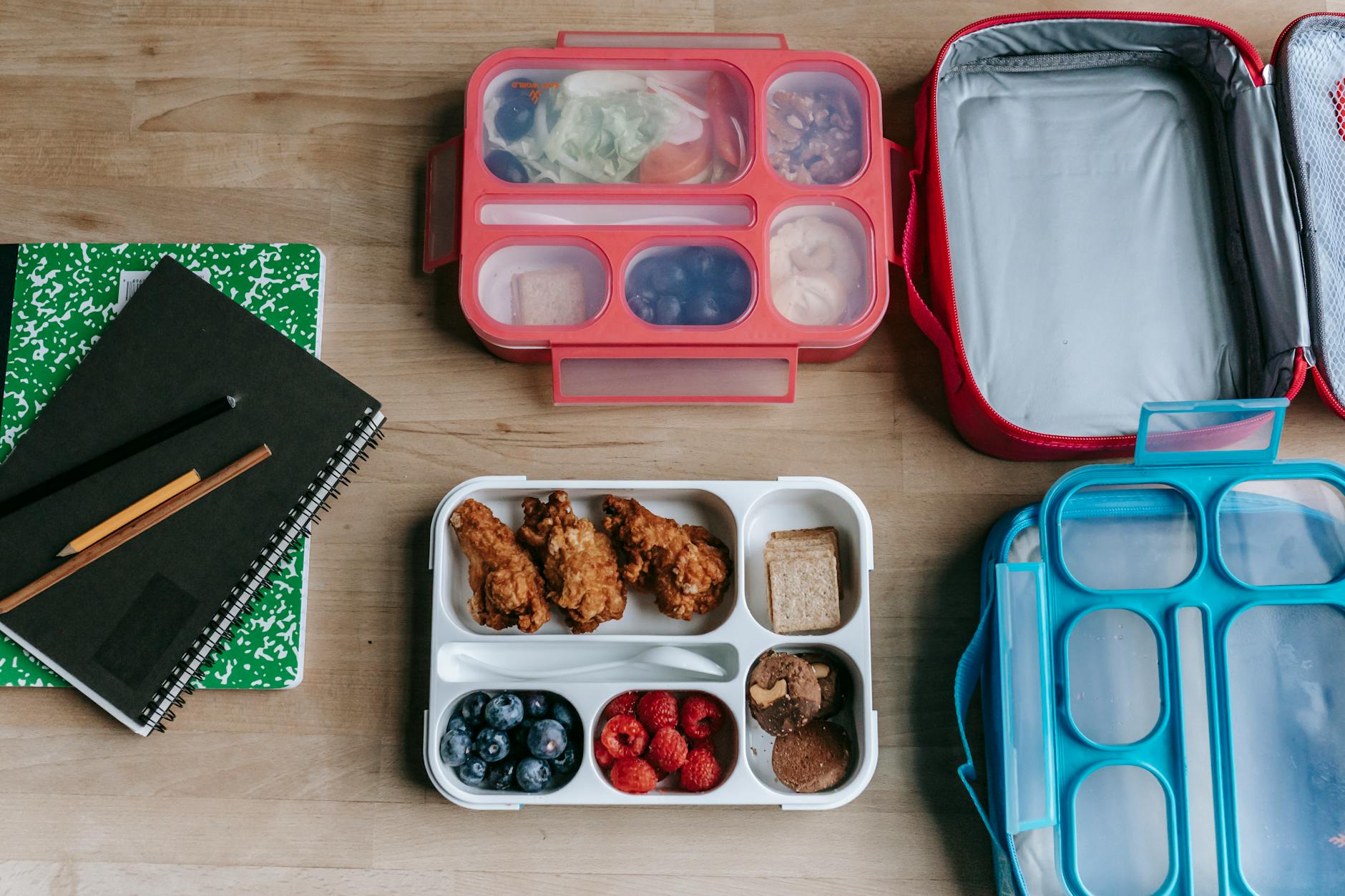Overhead view of a nutritious packed lunchbox with fresh fruits and whole foods for school