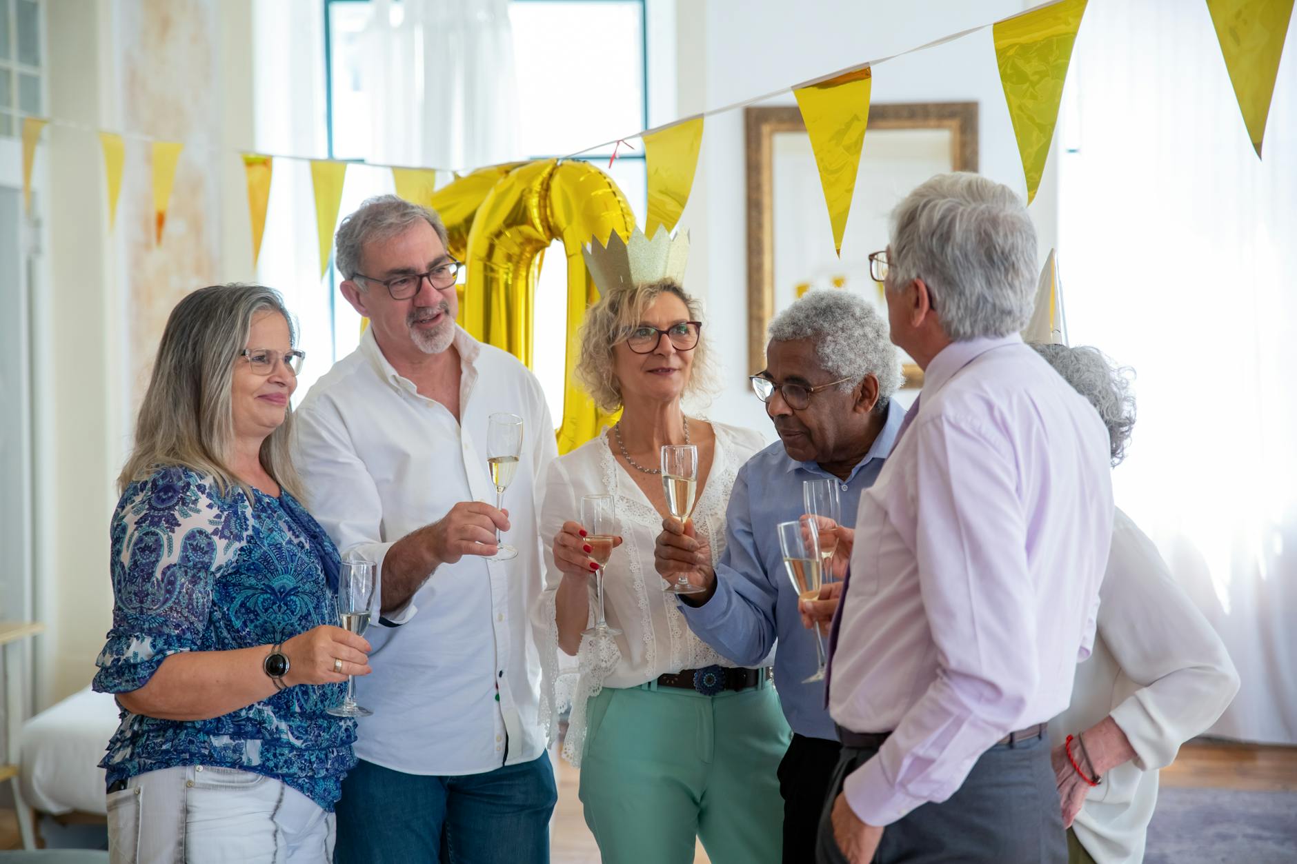 Senior friends laughing and celebrating together at a social gathering