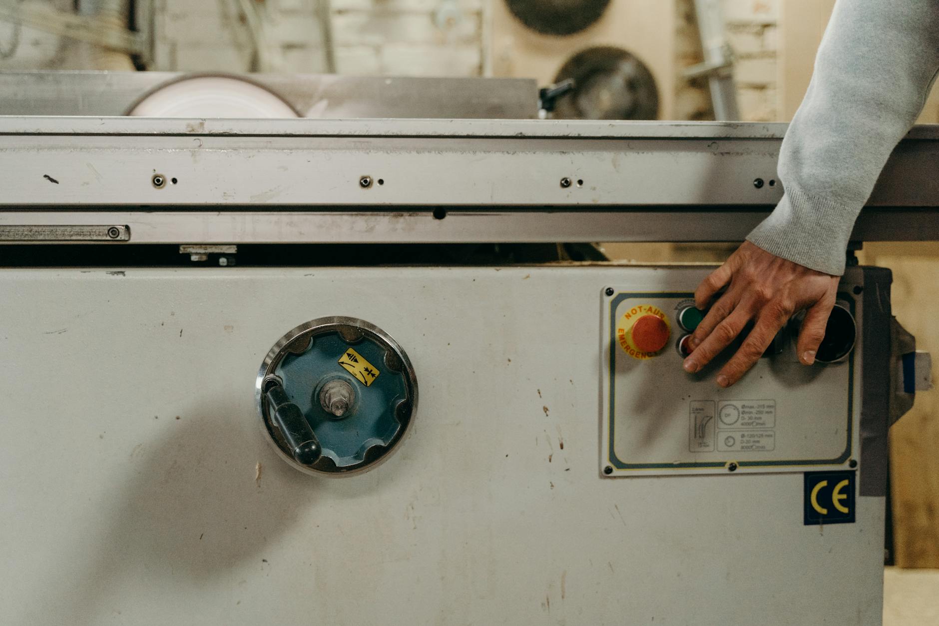 Close-up of a carpenter using a circular saw in a woodworking workshop