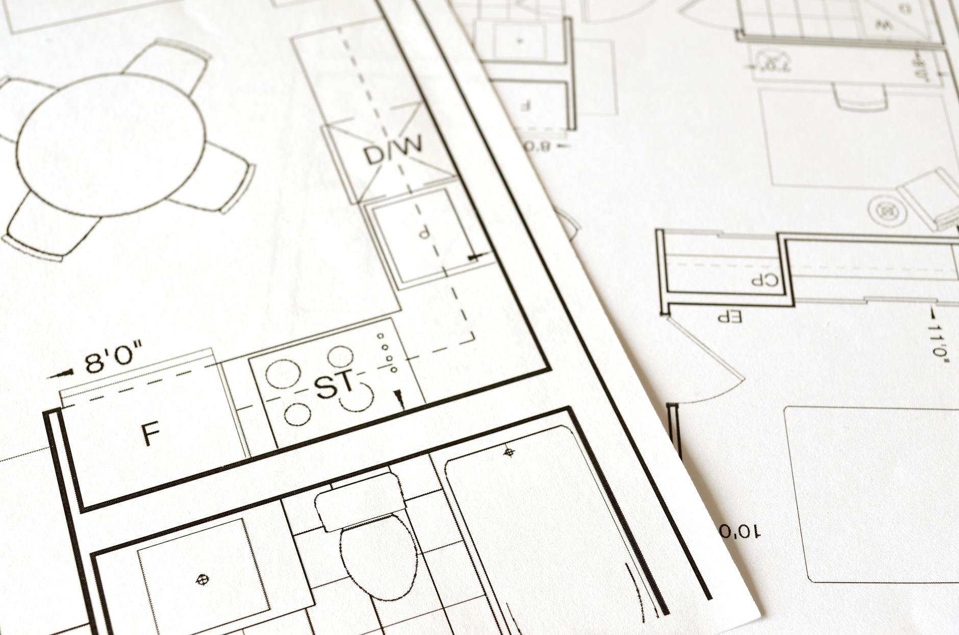 Close-up of an architectural floor plan on paper showing room layouts — similar to what a home fire escape plan map looks like