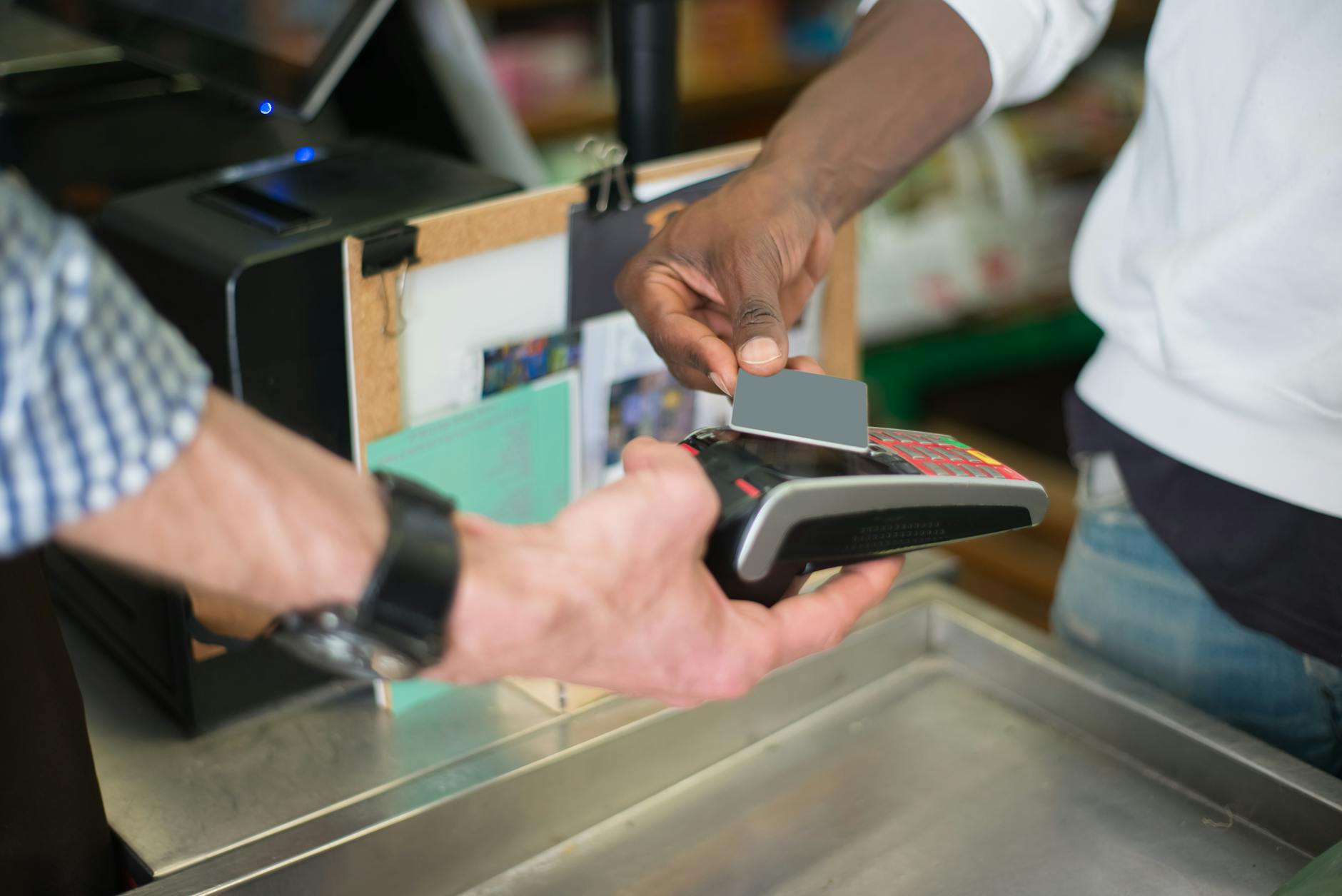 Customer using tap to pay contactless card at a retail store checkout