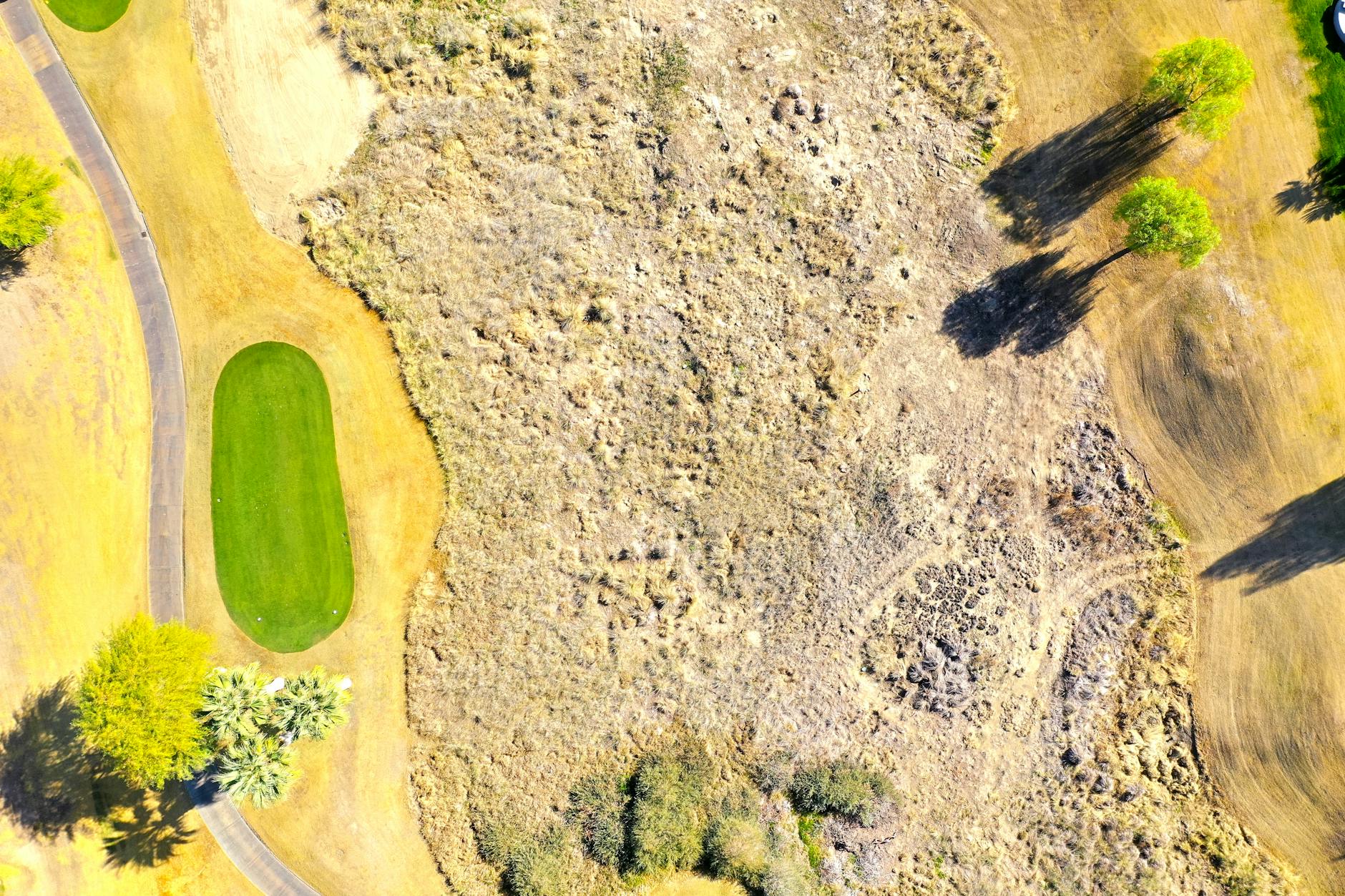 Aerial view of a golf course showing greens, fairways, and natural terrain