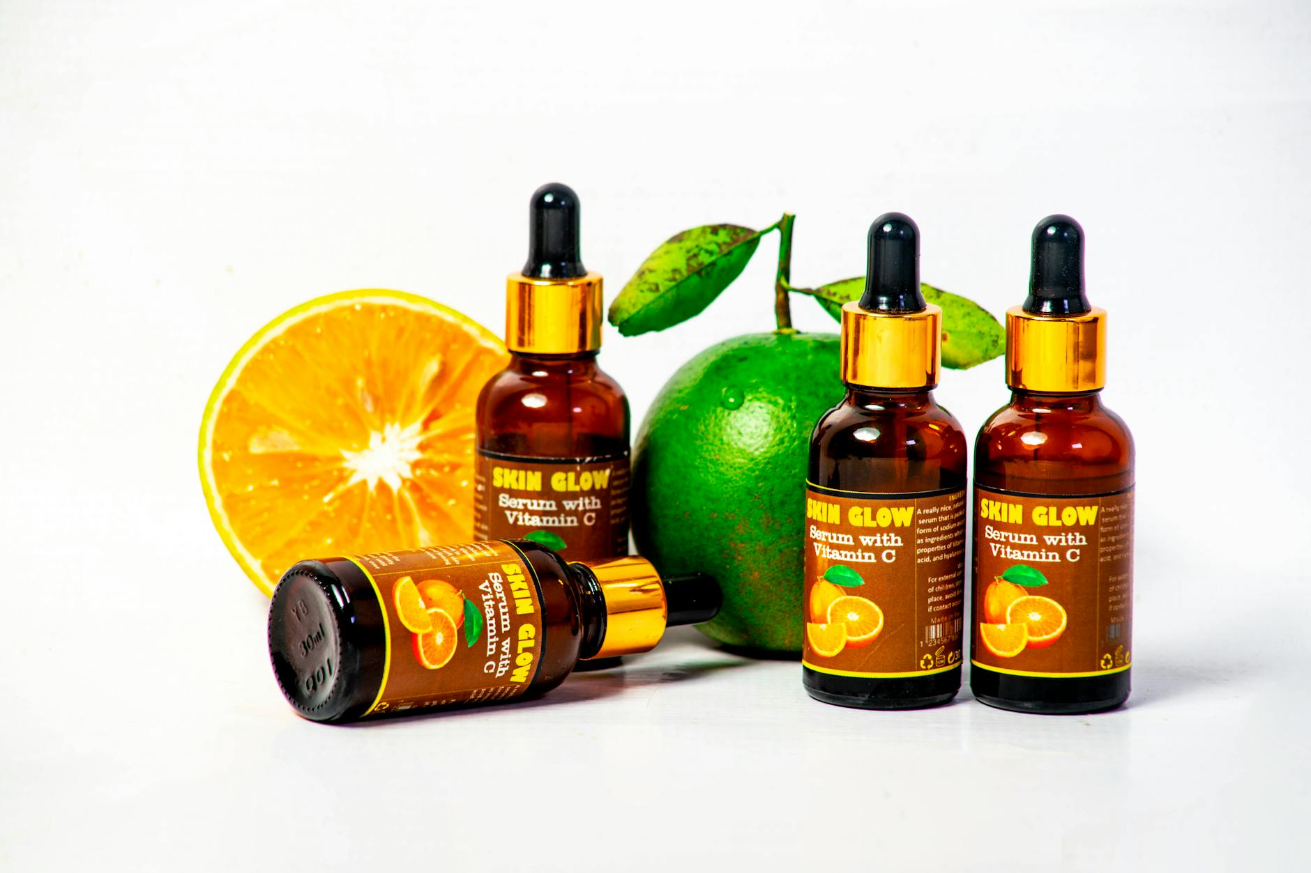 Vitamin C for Collagen Production — Topical and Dietary Sources Vitamin C serum with fresh citrus fruits — topical and dietary collagen boosting treatments