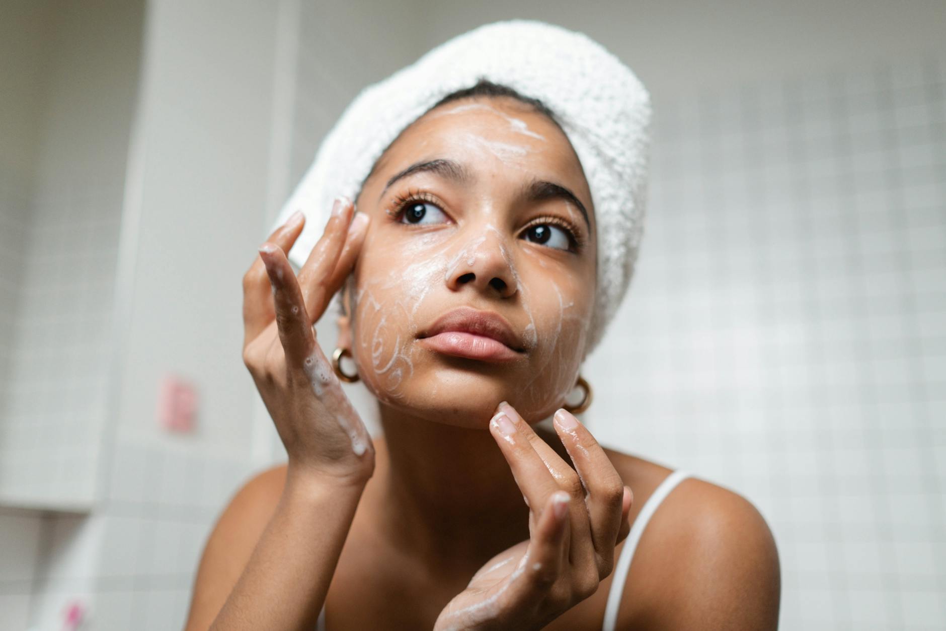 Topical Skincare Routine for Collagen Boosting Woman applying skincare cream — consistent topical routines support collagen production