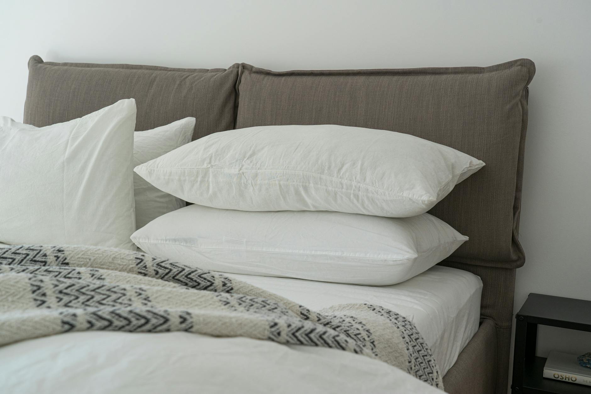 How to Care for Bed Sheets — Clean Bedroom 2026 Clean white bed sheets on a neatly made bed in a bright modern bedroom