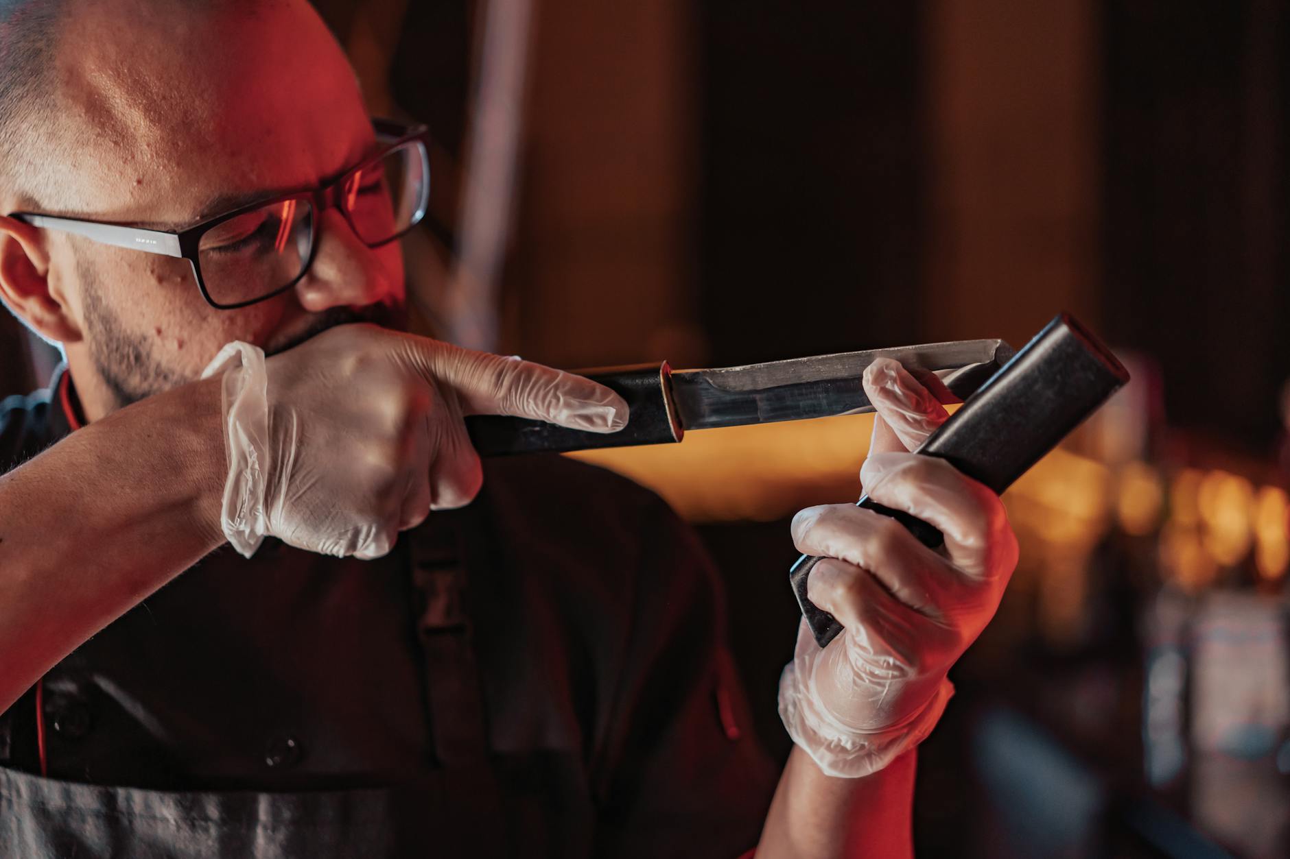 Chef sharpening a kitchen knife with precision and proper technique