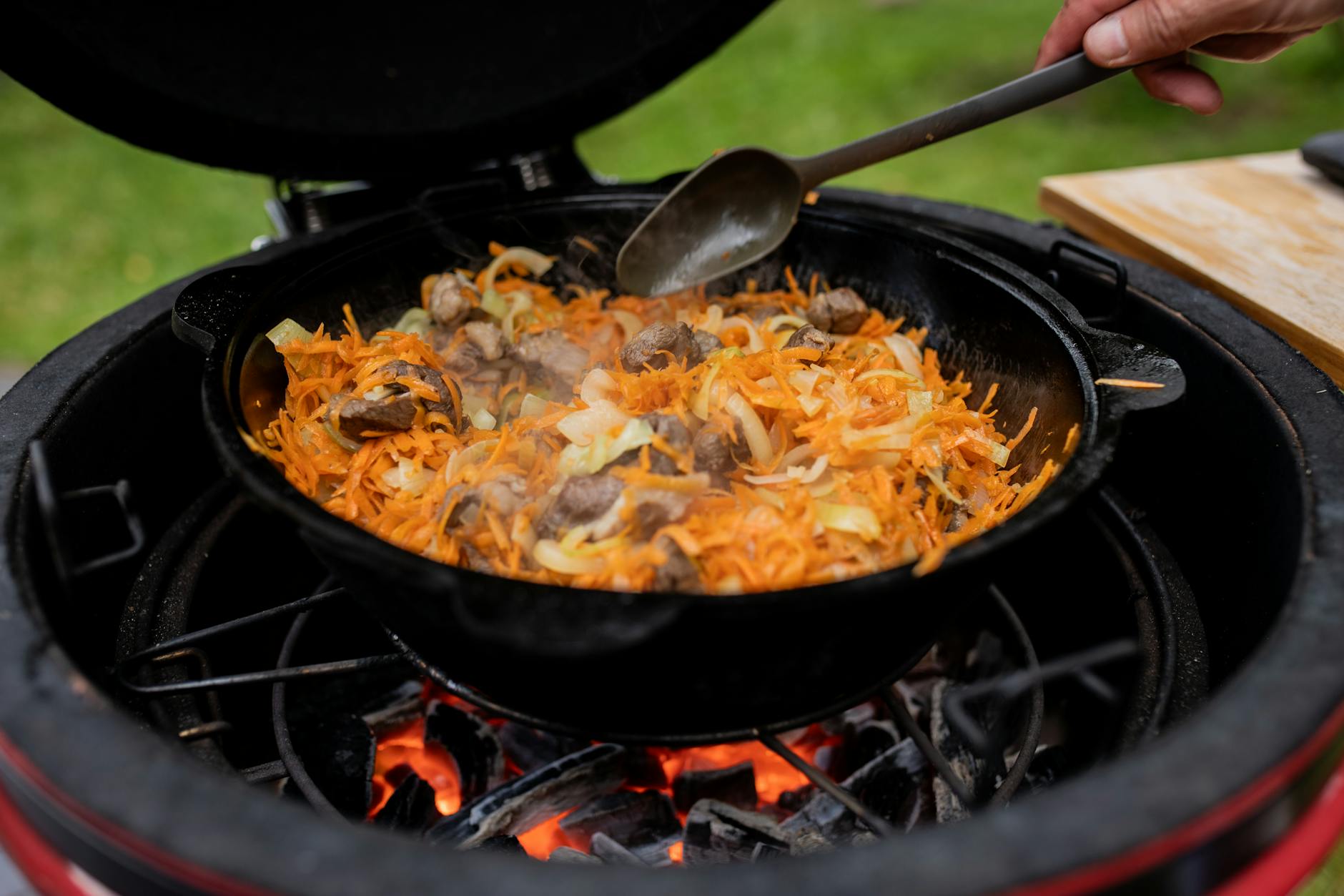 Cast iron skillet with food cooking over open flame — a scenario where grease fire risk is high