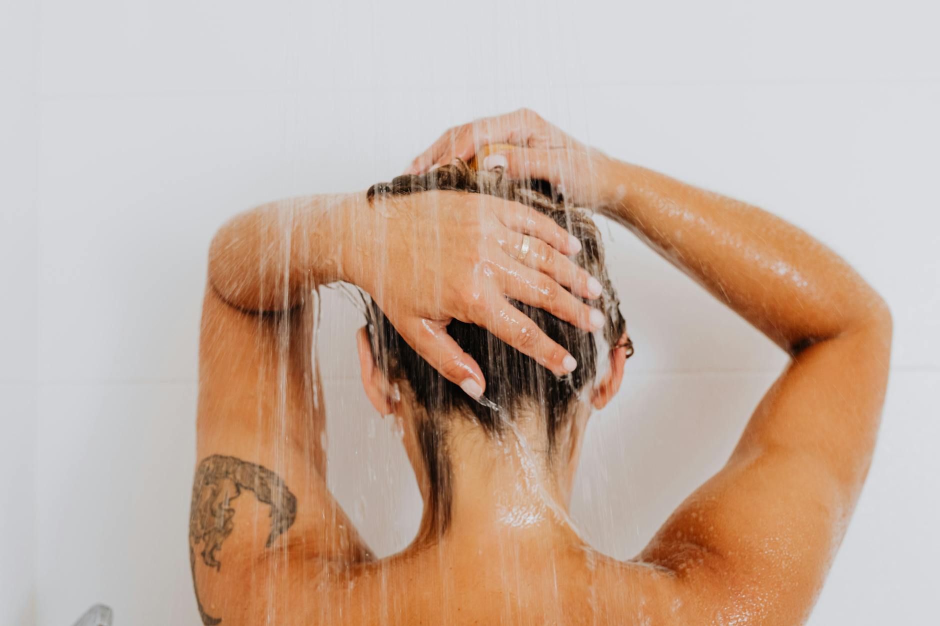 Person taking a cold shower as part of a morning wellness routine to stimulate the vagus nerve